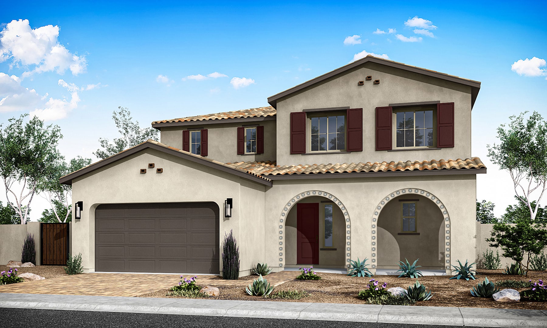 A two-story Mediterranean-style house with a red tile roof, stucco exterior, and a garage door stands in a well-landscaped yard with plants and shrubs in the foreground, against a backdrop of a clear blue sky with fluffy white clouds.