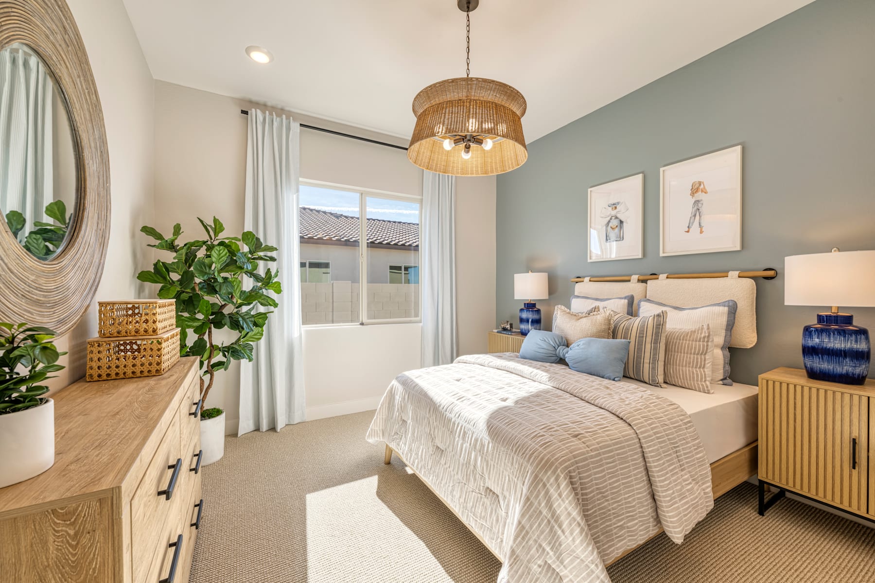 A cozy and inviting bedroom with a large bed, neutral-toned bedding, and a variety of decorative elements, including a woven pendant light, potted plants, and framed artwork on the walls.