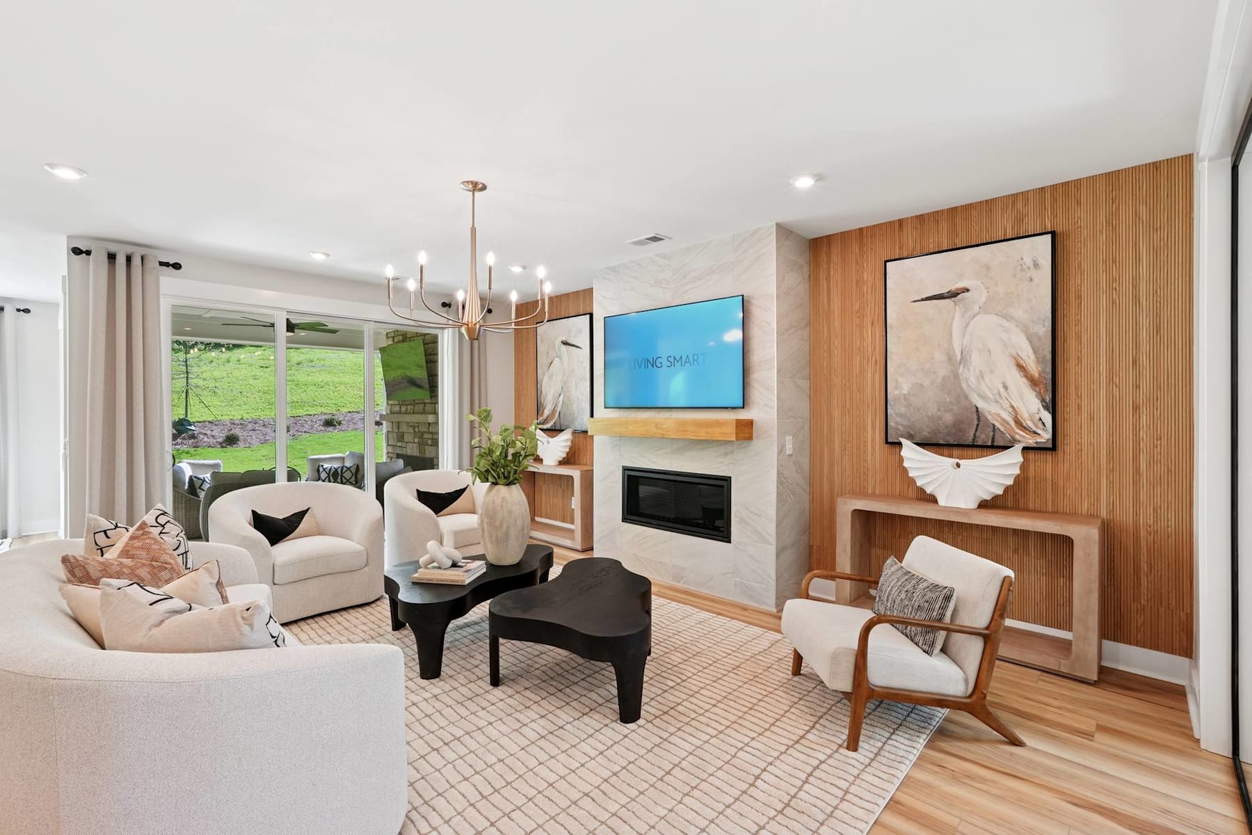 A cozy and well-decorated living room with comfortable seating, a fireplace, and various decorative elements, including artwork and plants, creating a warm and inviting atmosphere.