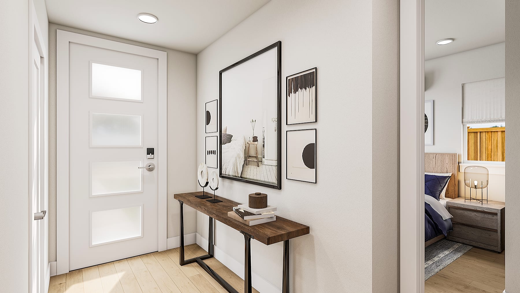 A modern and minimalist entryway with a wooden console table, framed artwork, and a partially visible bathroom in the background.