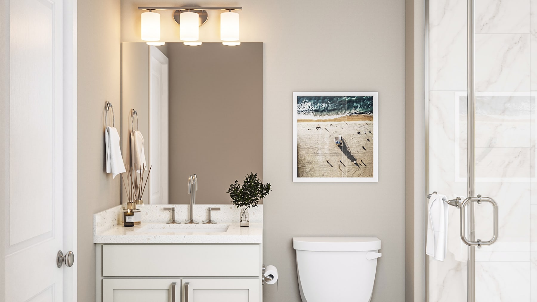 A modern and minimalist bathroom with a white vanity, a framed artwork on the wall, and a glass shower enclosure.
