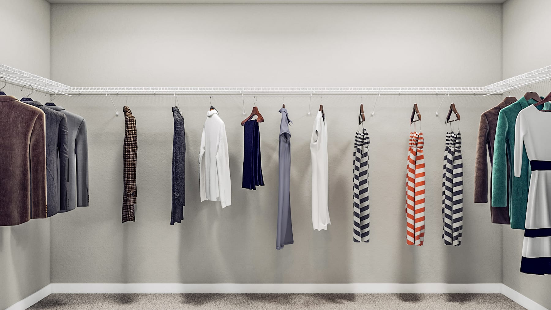 A well-organized clothing rack displaying a variety of colorful and patterned garments against a plain white wall background.