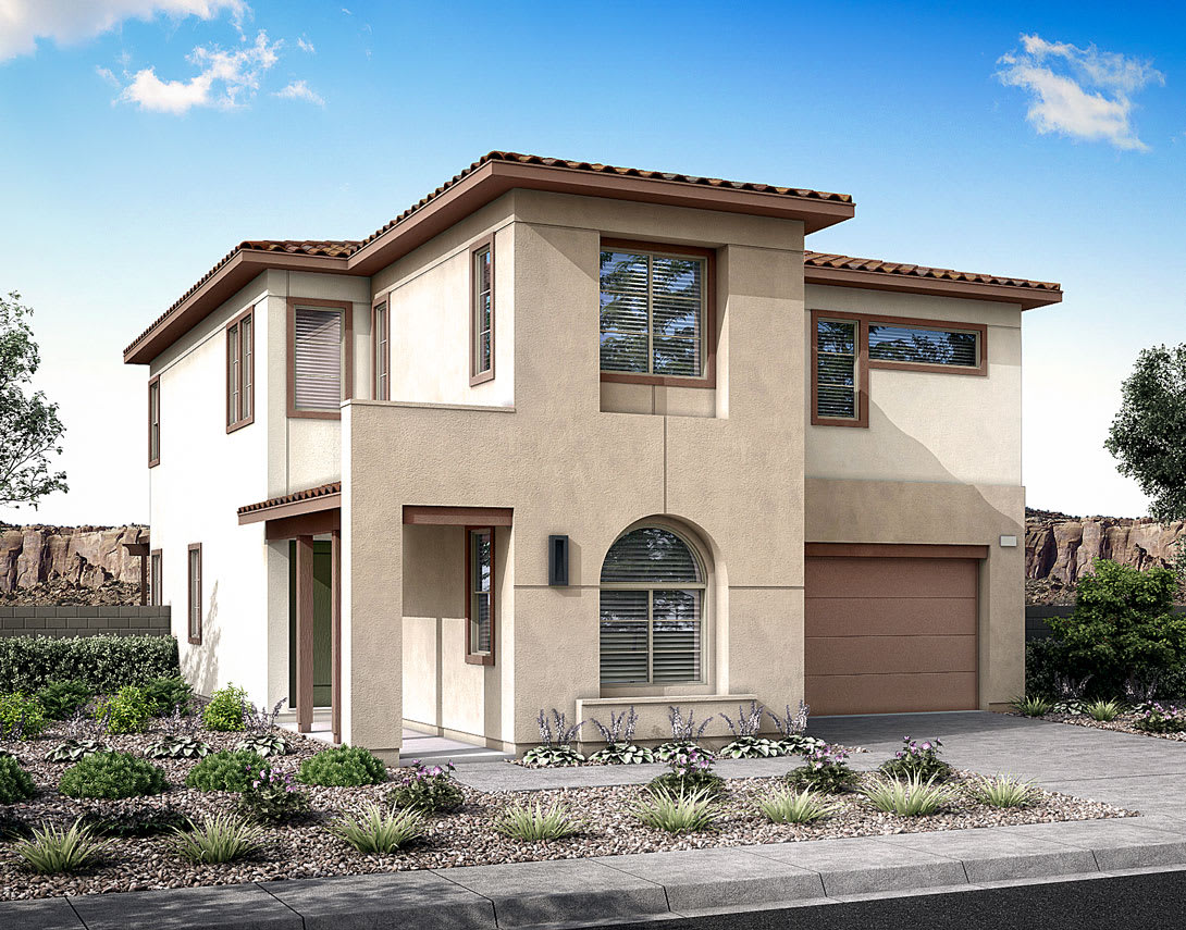 A two-story Mediterranean-style house with a tiled roof, stucco exterior, and a landscaped front yard featuring rocks and desert plants.
