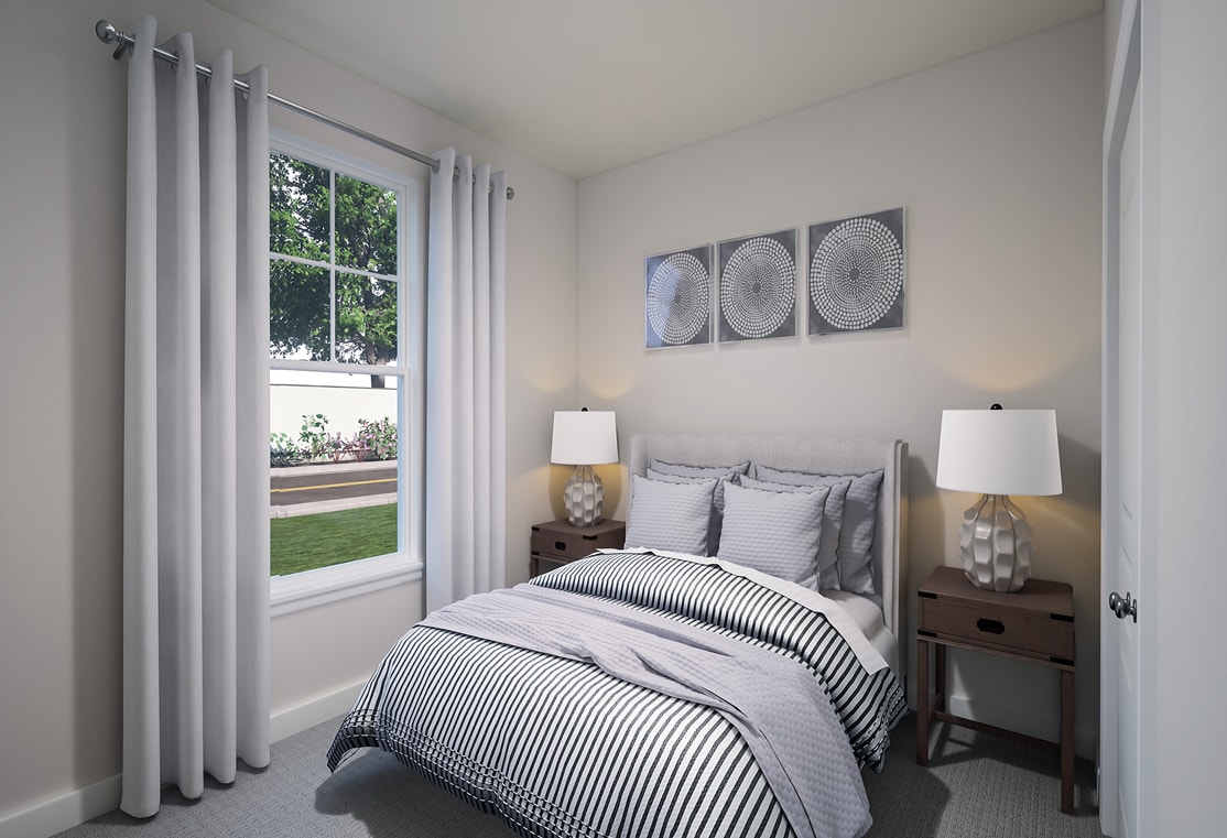 A cozy and well-designed bedroom with a large window overlooking a grassy outdoor area, featuring a striped bedding set, nightstands, and decorative wall art.