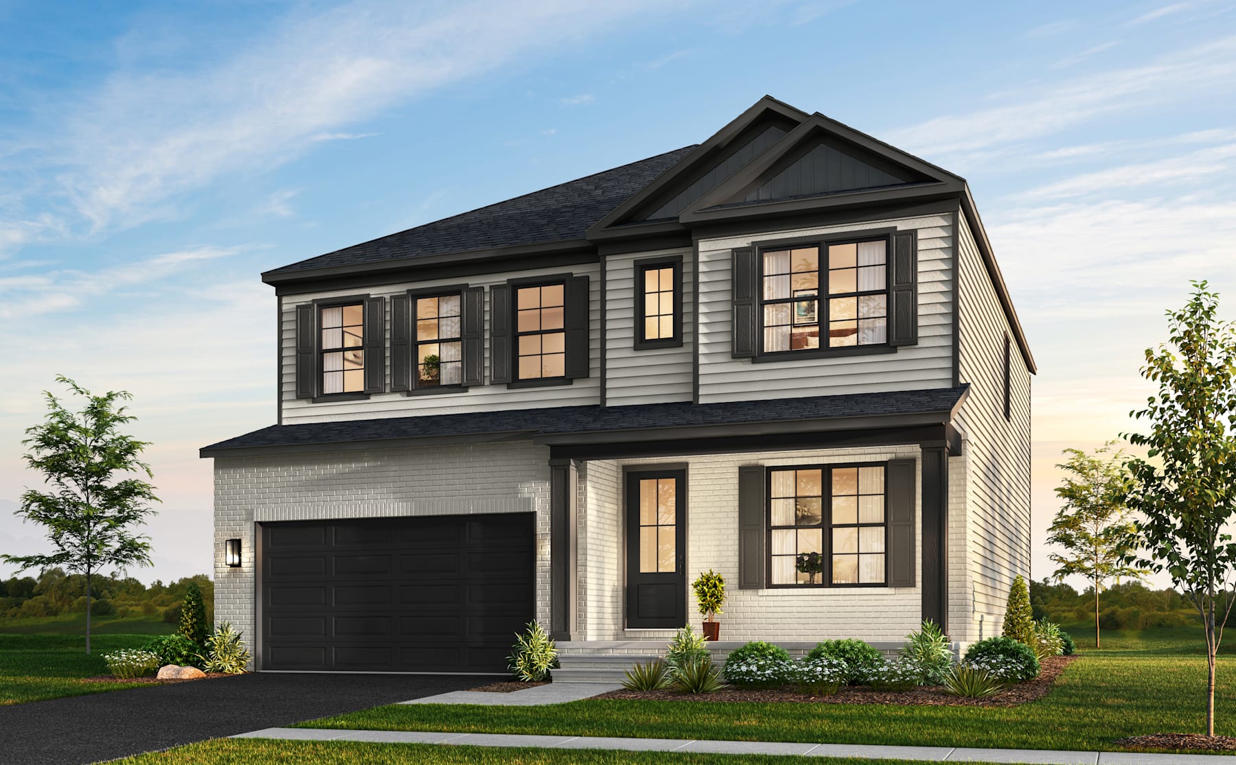 A two-story residential house with a garage, surrounded by a grassy lawn and trees in the background, under a partly cloudy sky.