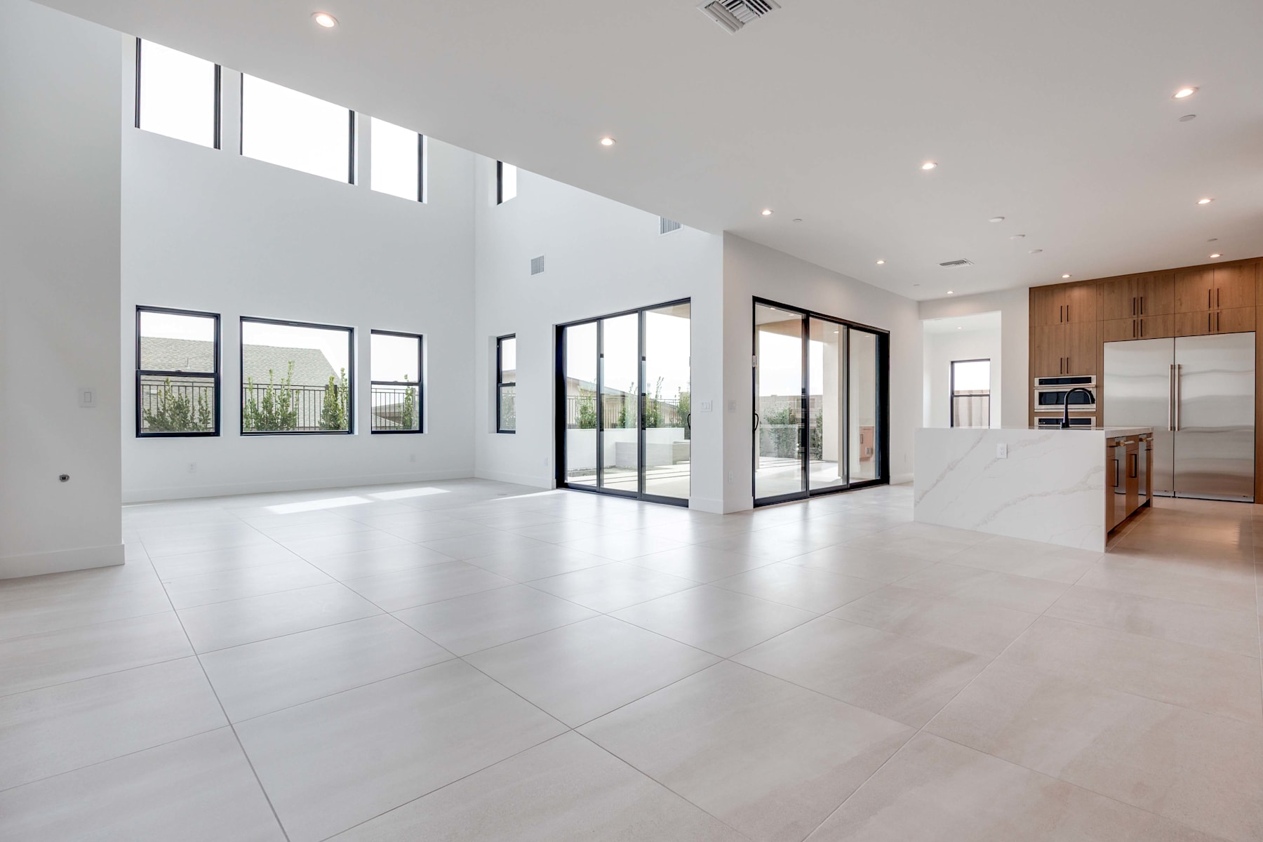 A spacious, modern interior with large windows, white walls, and a sleek, minimalist design.