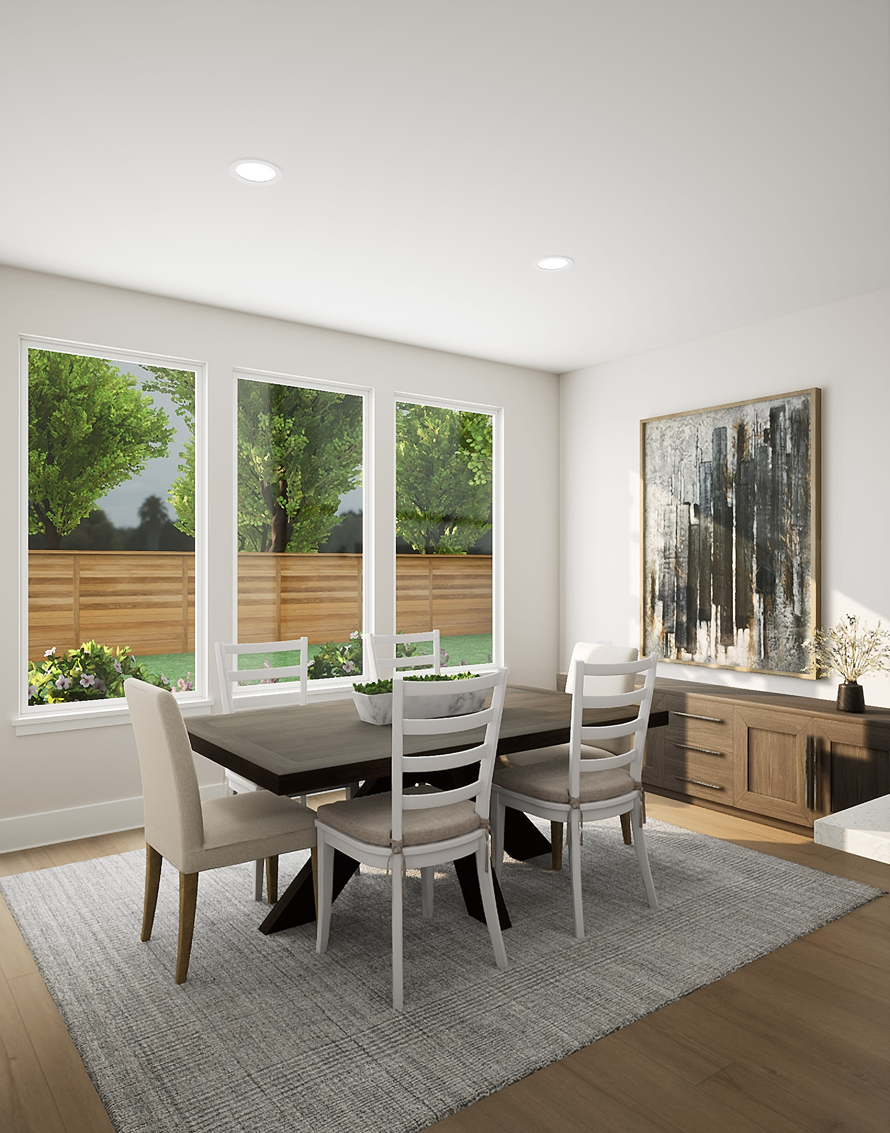 A modern and spacious dining room with a large wooden table surrounded by chairs, a wooden sideboard, and a large abstract painting on the wall. The room features large windows overlooking a lush, green outdoor area.
