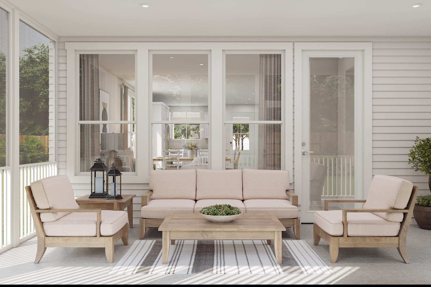 A cozy and inviting outdoor living space with a comfortable seating arrangement, a wooden coffee table, and a striped rug on the porch, surrounded by a white exterior and large windows that allow natural light to flood the area.