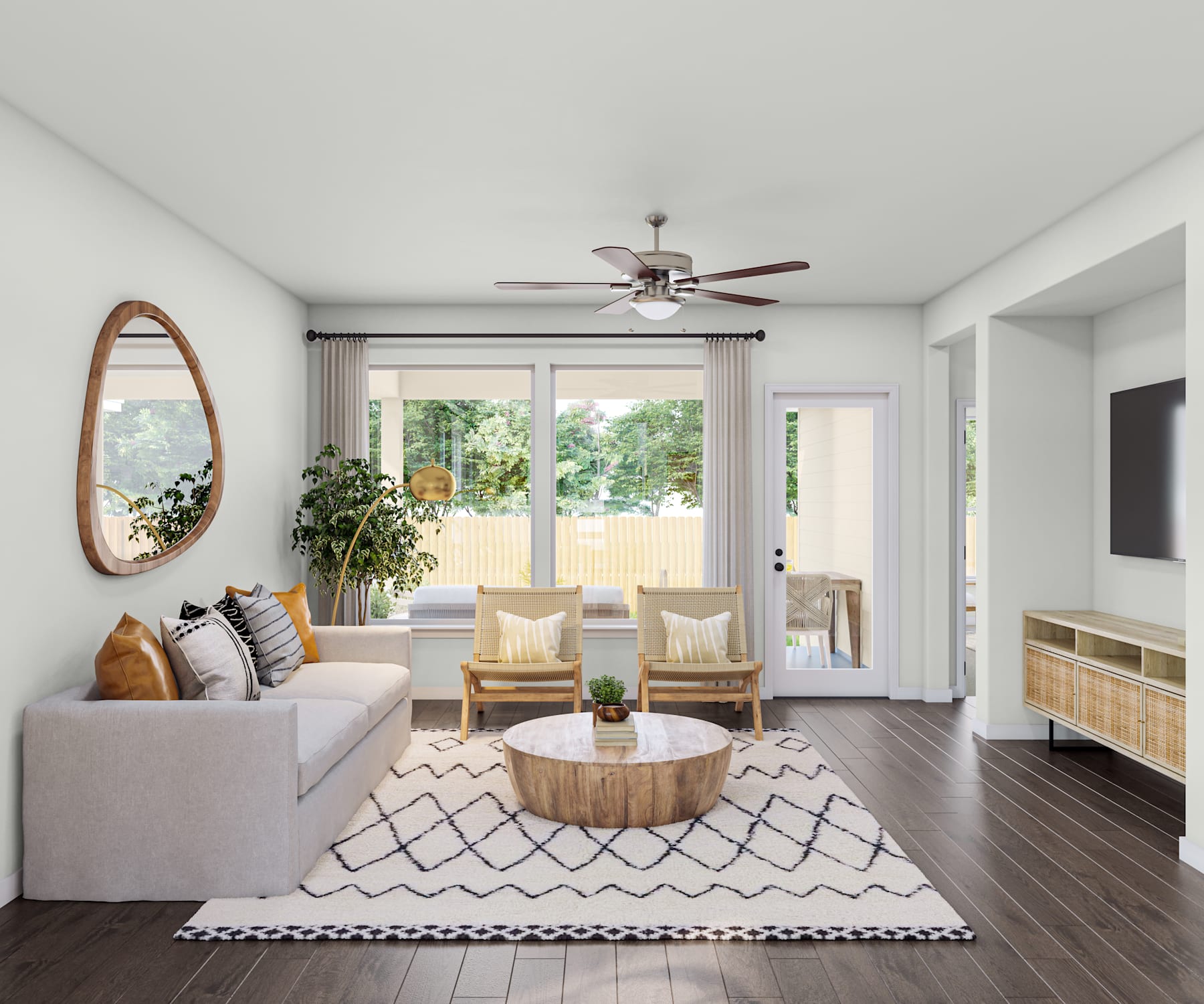 A cozy and inviting living room with a gray sofa, wooden coffee table, and two armchairs facing a large window that provides a view of the outdoor greenery.