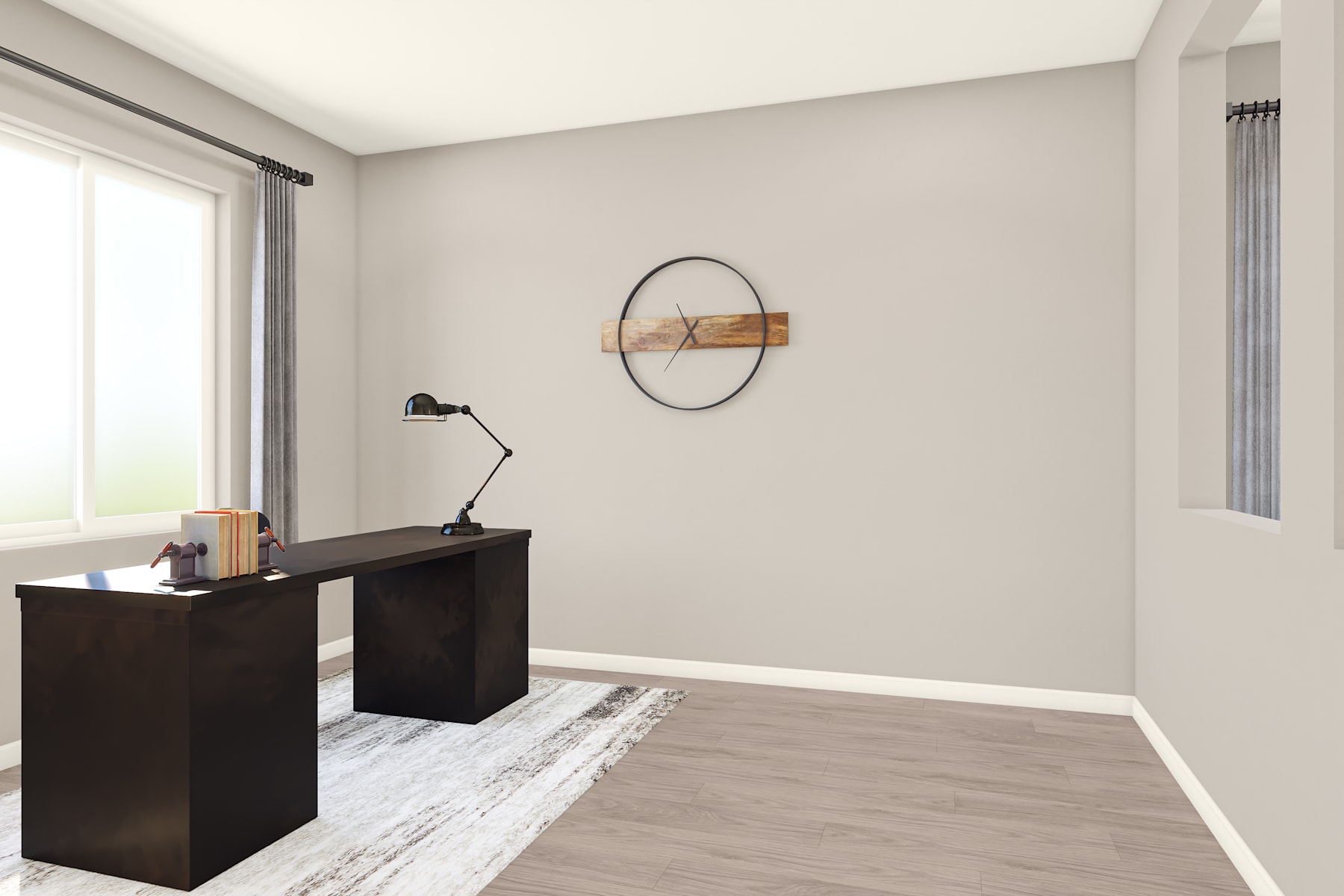 A minimalist home office space with a dark wooden desk, a circular wall decor, and a lamp, set against a light-colored wall and hardwood flooring.