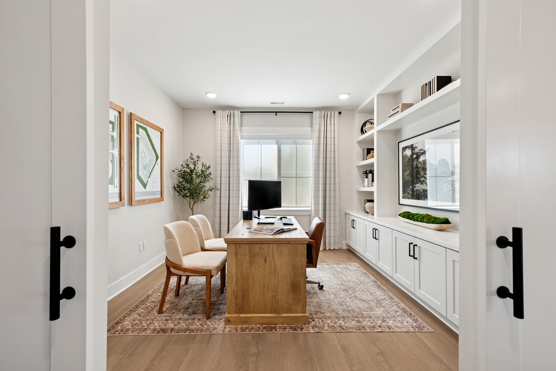 A cozy and well-designed home office space with a wooden desk, comfortable chairs, built-in shelving, and decorative elements that create a warm and inviting atmosphere.