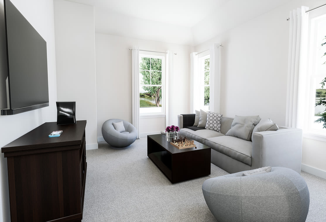 A modern and minimalist living room with a large TV, gray sofas, and a wooden coffee table, set against a backdrop of white walls and large windows overlooking a lush outdoor scene.