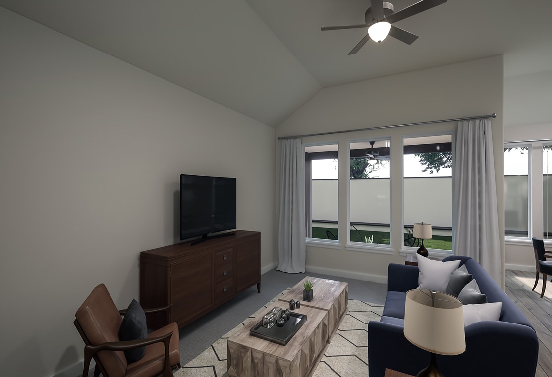 A modern living room with a television stand, a couch, and a ceiling fan, surrounded by large windows overlooking a scenic outdoor view.