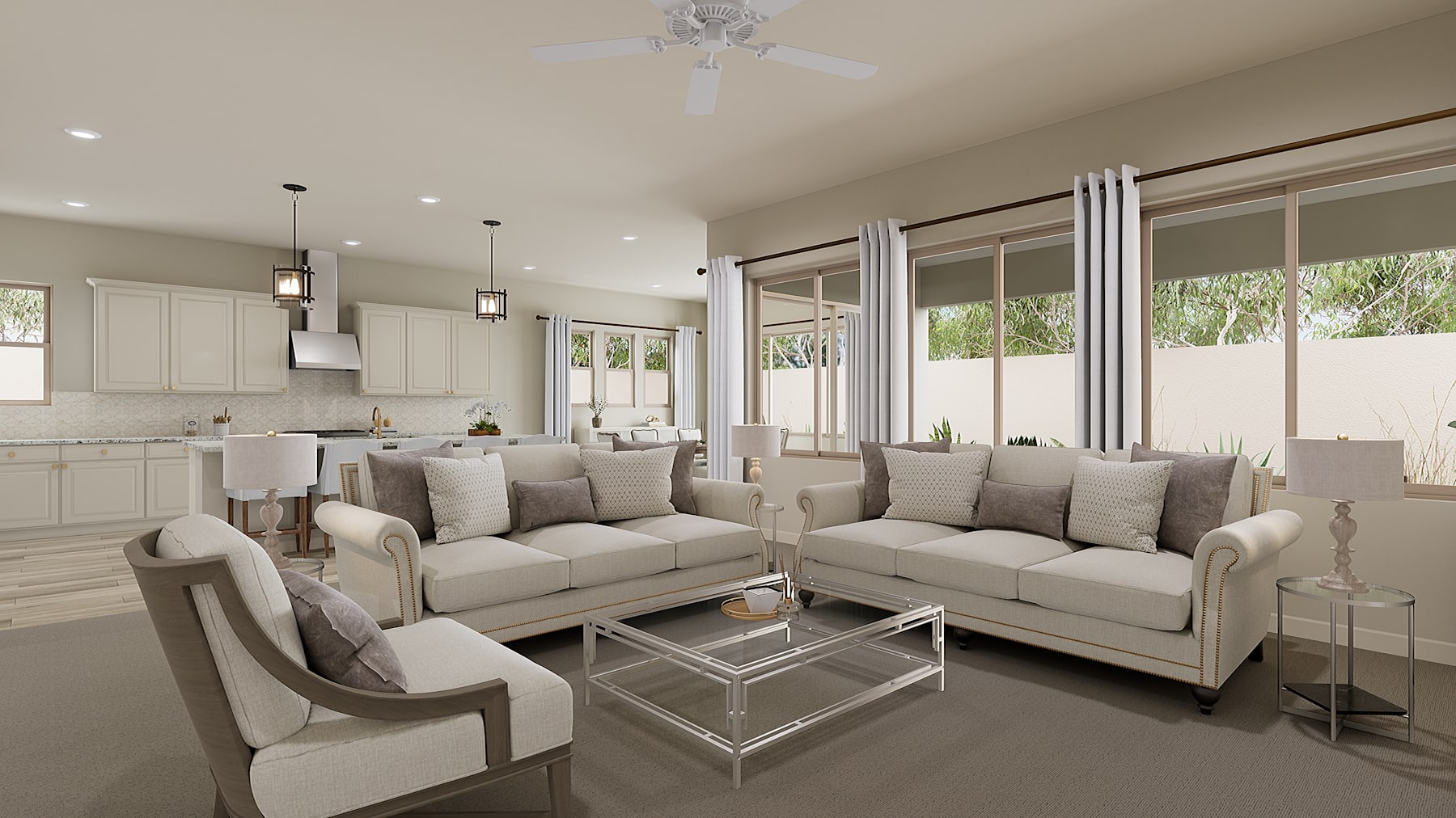A spacious and well-lit living room with comfortable beige sofas, a glass-topped coffee table, and large windows overlooking a scenic outdoor area.
