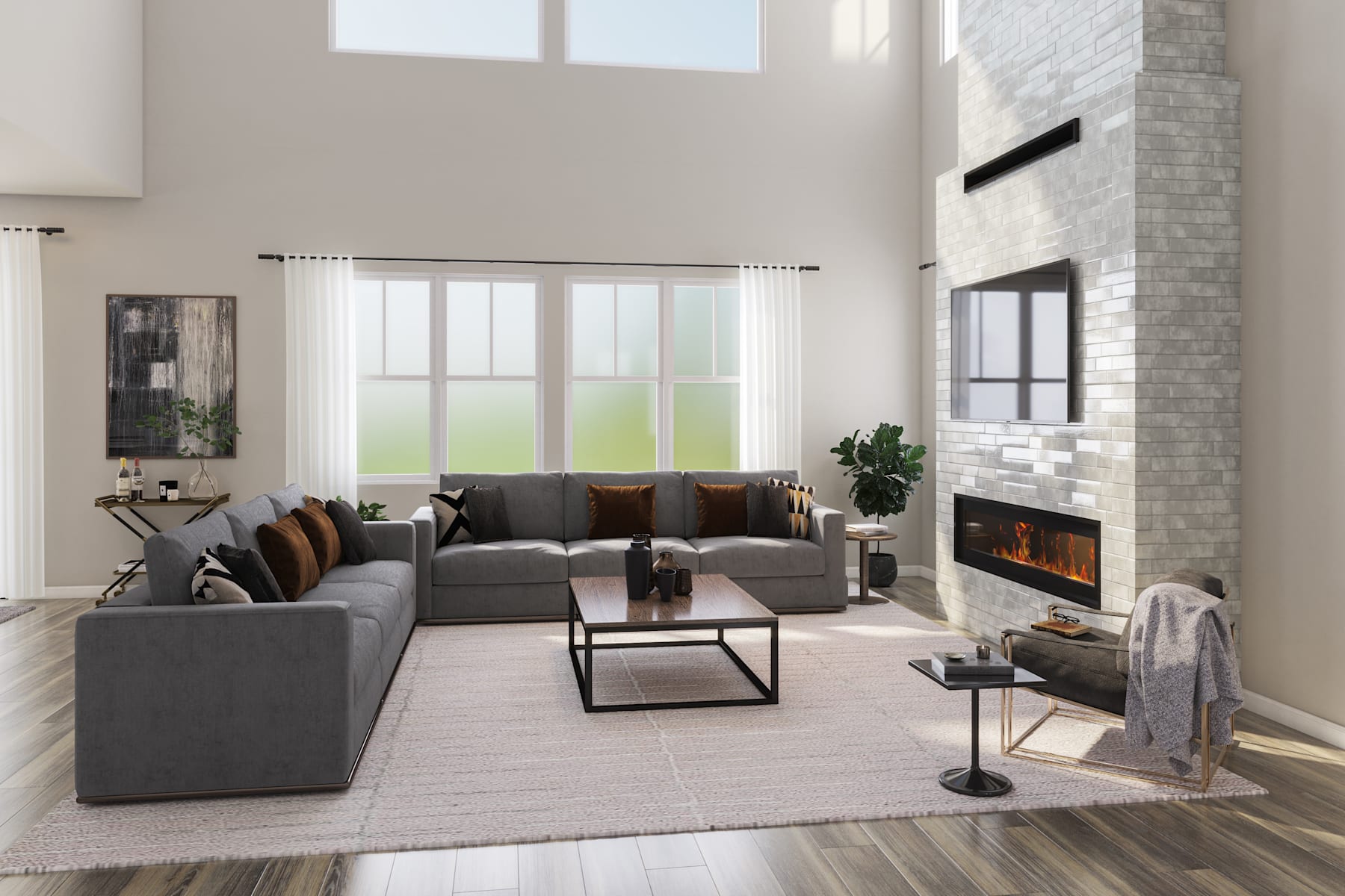 A spacious and modern living room with a large gray sectional sofa, a fireplace, and large windows overlooking a scenic outdoor view.
