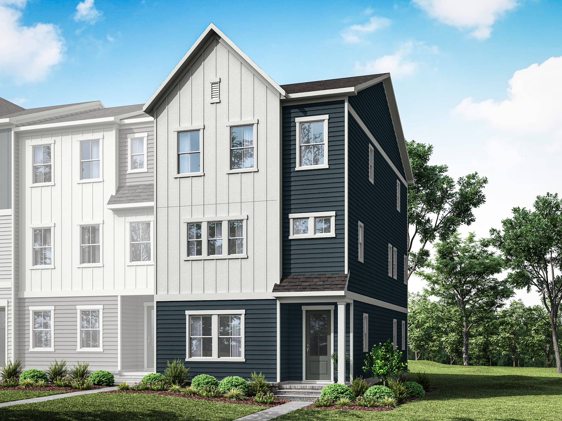 A modern, multi-story townhouse with a gray and white exterior stands in a grassy area surrounded by trees.