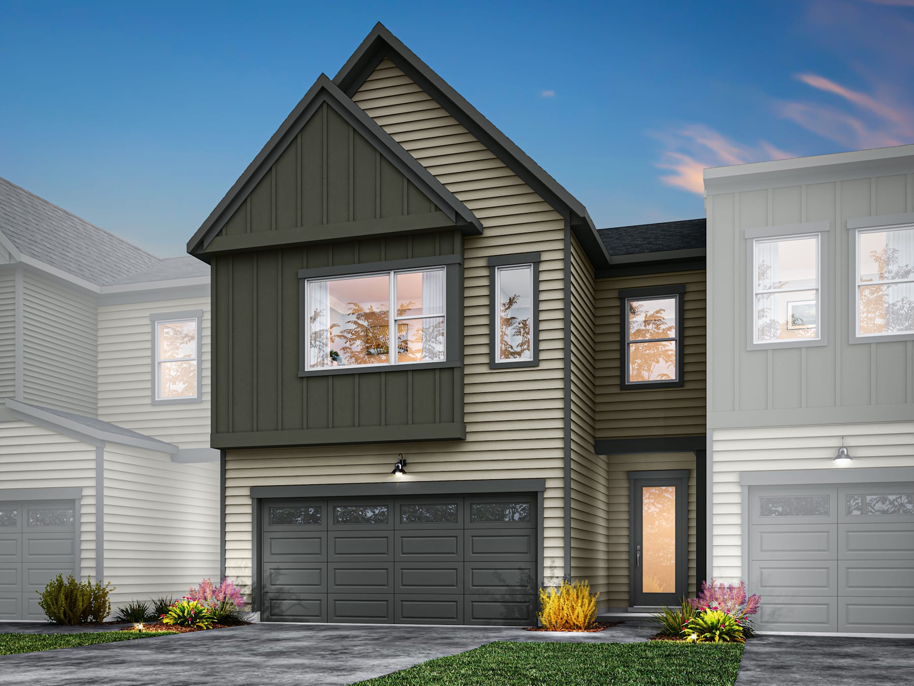 A modern two-story townhouse with a gabled roof, gray siding, and a garage door in the foreground, set against a clear blue sky in the background.