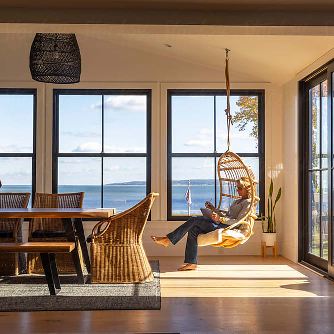 A woman in a hanging chair in a kitchen