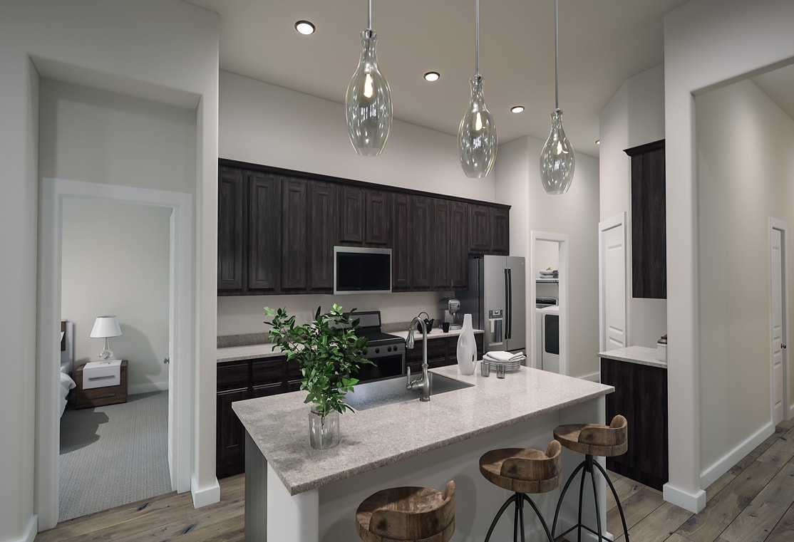 A modern and sleek kitchen with dark cabinets, a white countertop, and pendant lights hanging above the island.
