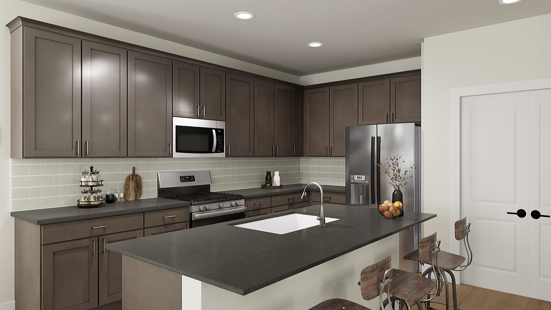 A modern, well-equipped kitchen with dark wood cabinets, stainless steel appliances, and a large central island with a black countertop.