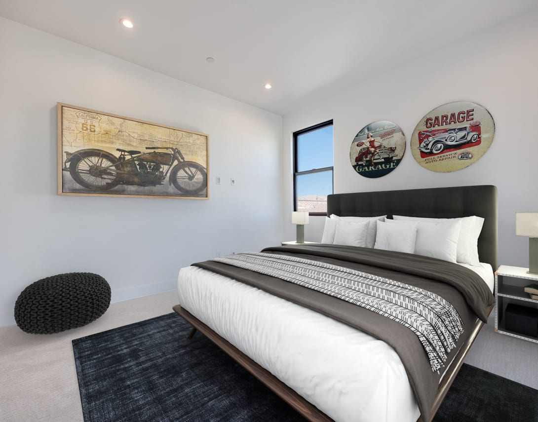 A modern and stylish bedroom with a large bed, framed artwork depicting a vintage motorcycle, and decorative circular wall hangings.