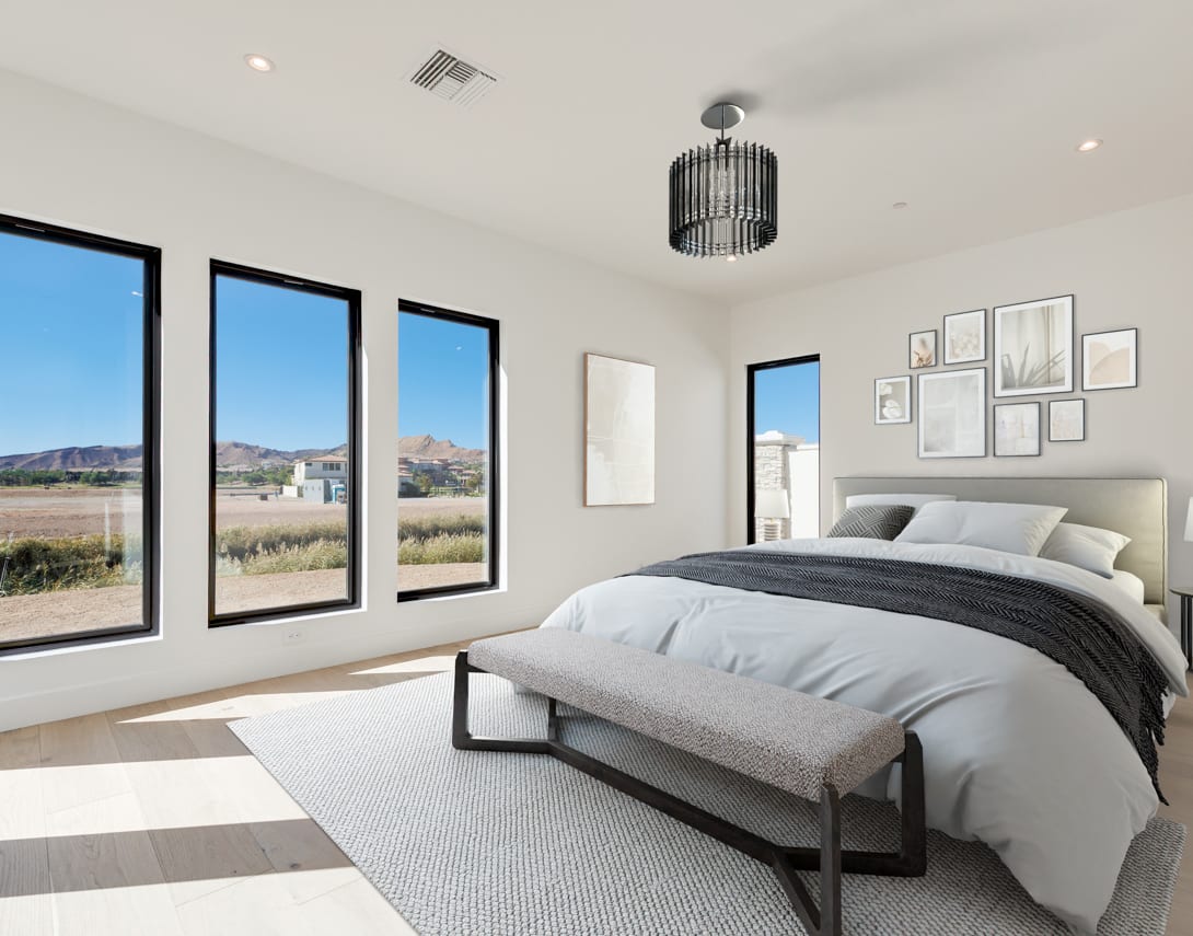 A spacious and modern bedroom with large windows offering a scenic view of the surrounding landscape, featuring a plush bed, minimalist decor, and a stylish pendant light.
