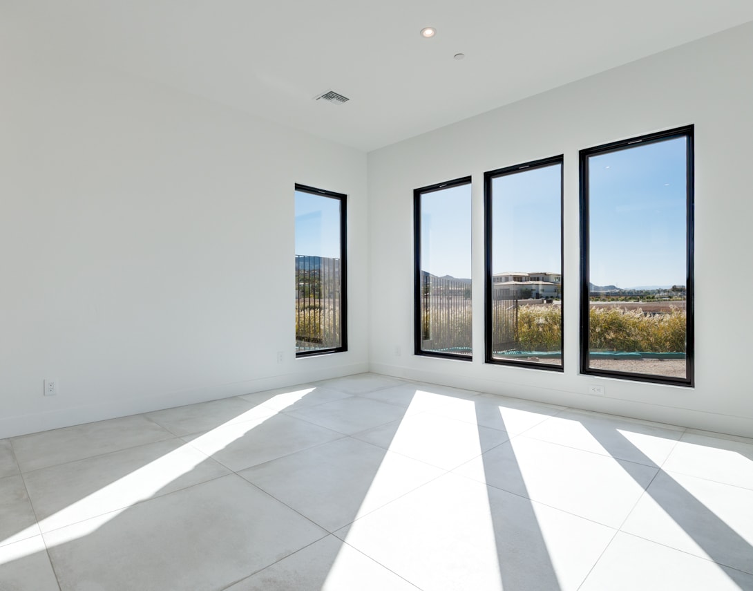 A bright, spacious room with large windows overlooking a scenic outdoor landscape.