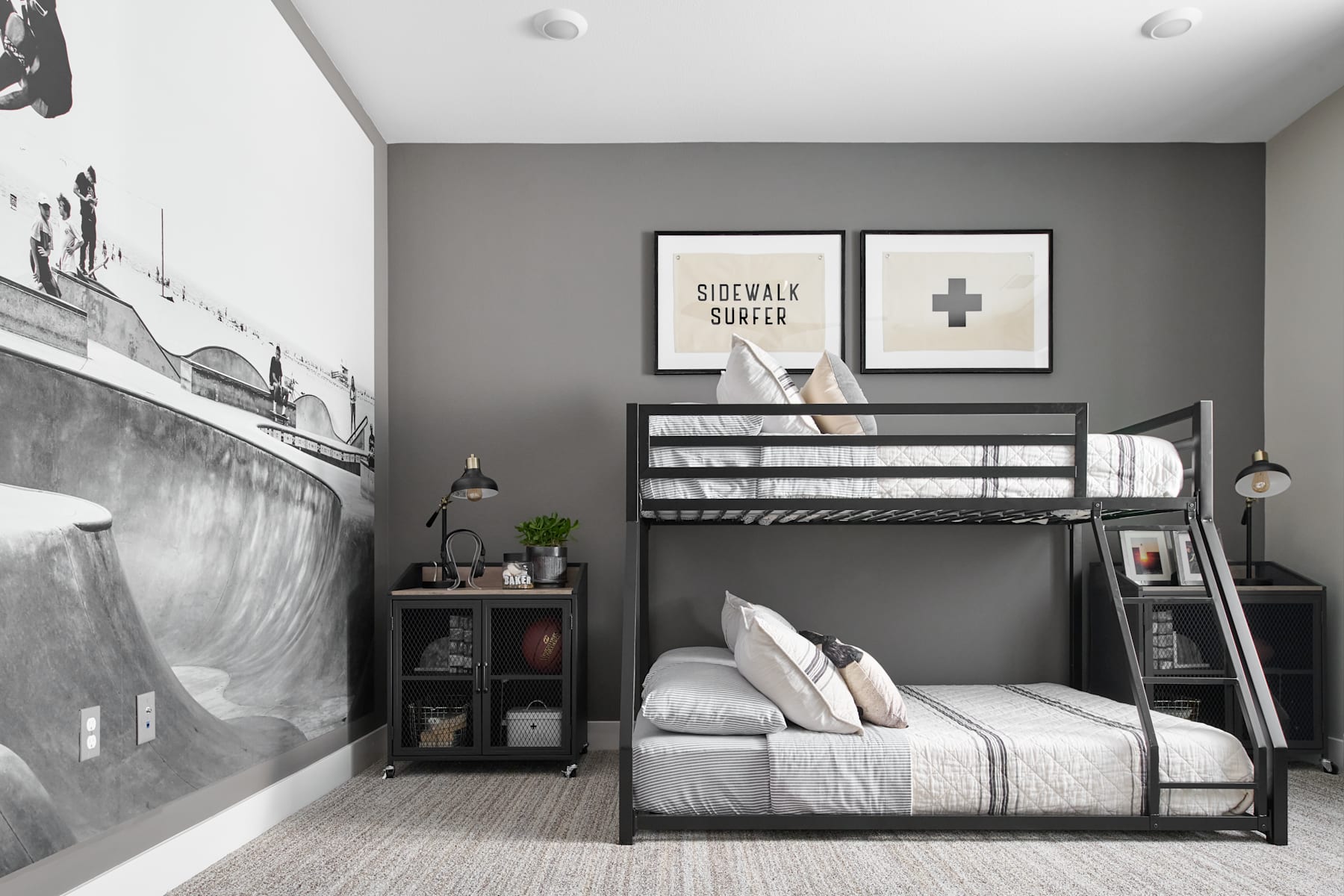 A cozy and modern bedroom with a black metal bunk bed, shelves, and wall decor in a neutral color scheme.