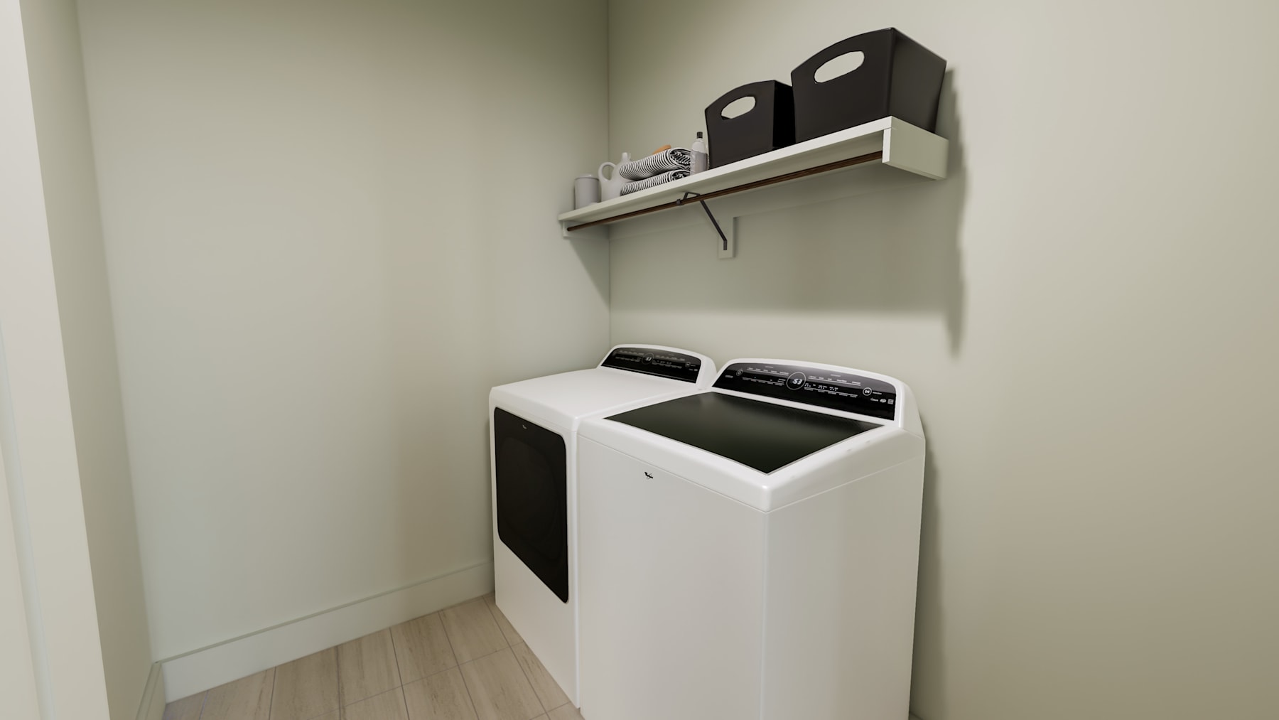 A white washing machine stands on a wooden floor, with a shelf above it holding speakers or other audio equipment.