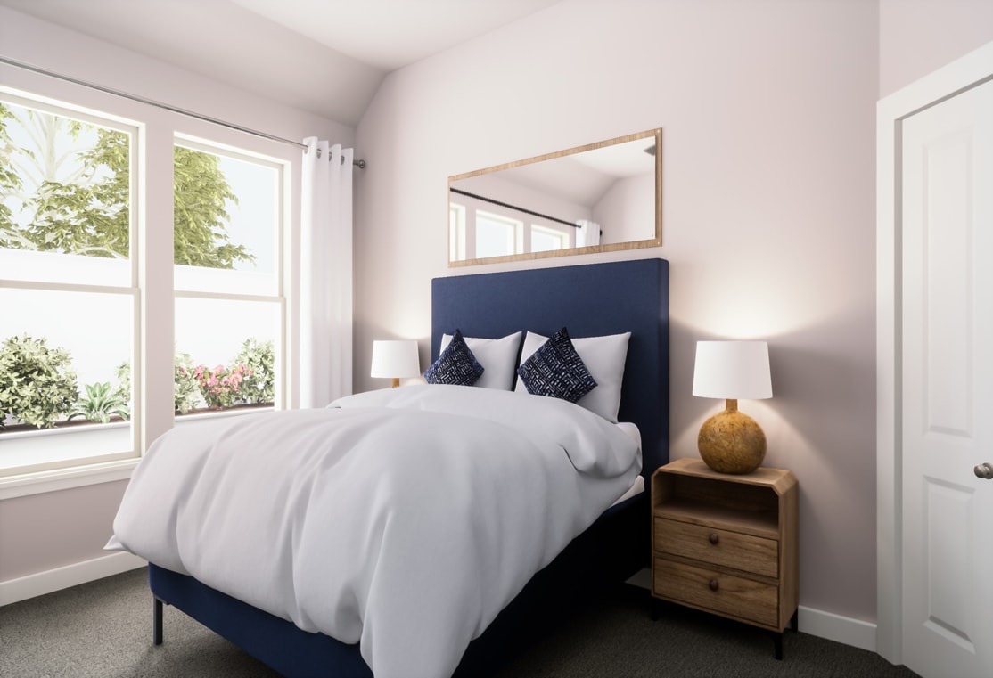 A cozy and well-appointed bedroom with a large window overlooking lush greenery, featuring a navy blue upholstered headboard, white bedding, and wooden nightstands.