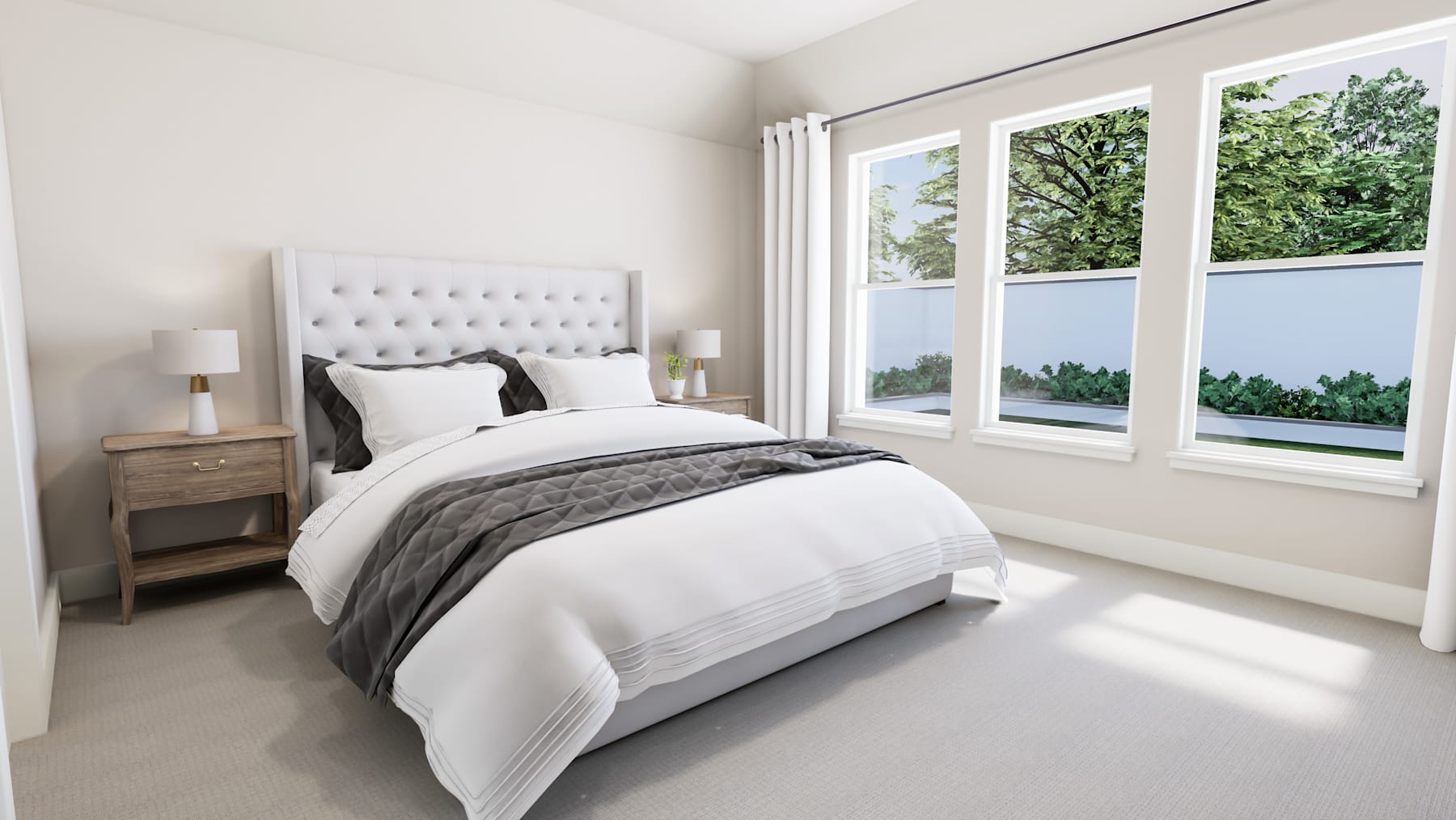 A cozy and bright bedroom with a tufted headboard, neutral bedding, and large windows overlooking lush greenery outside.
