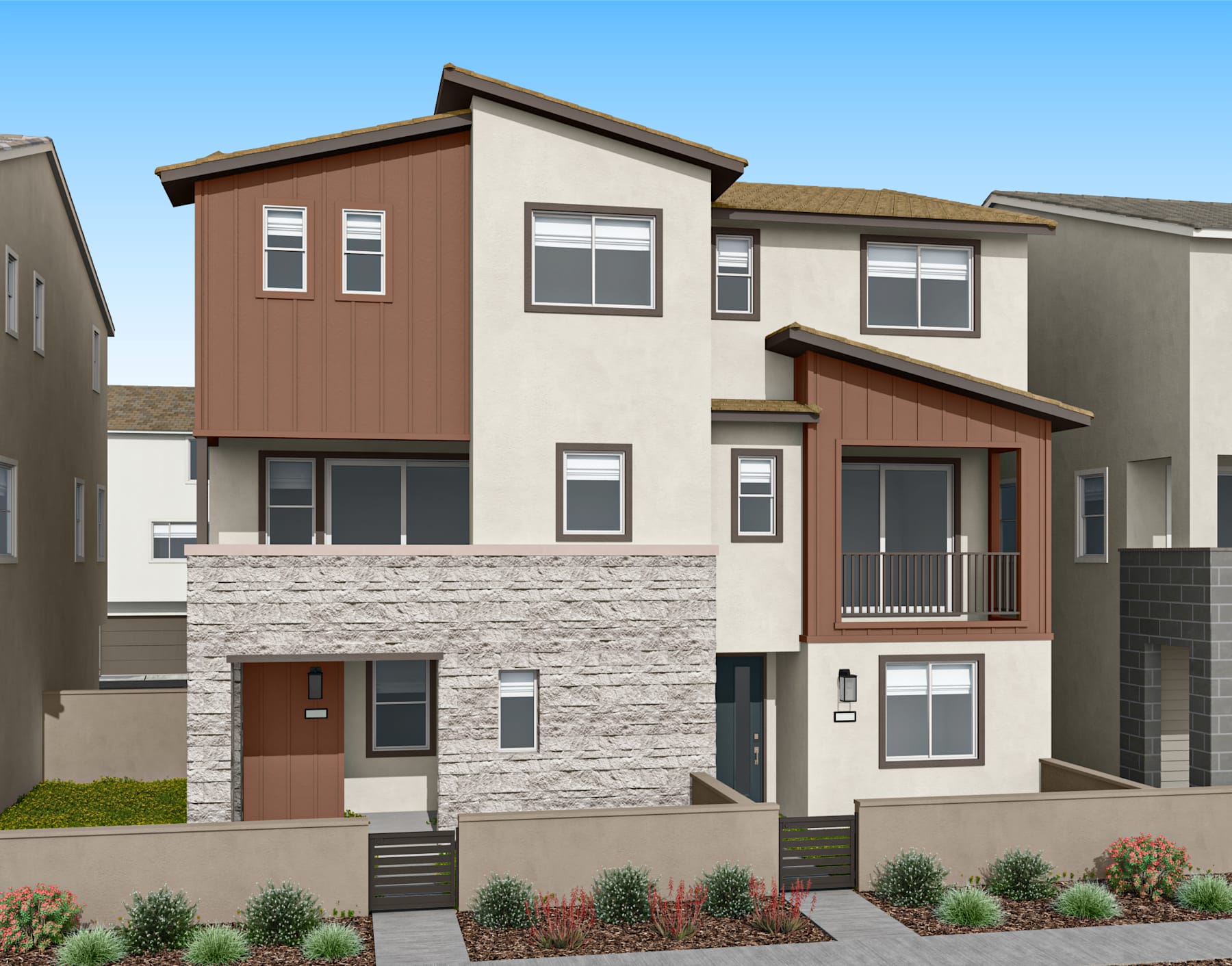 A modern, multi-story townhouse with a stone facade, wooden accents, and a well-landscaped front yard set against a clear blue sky.