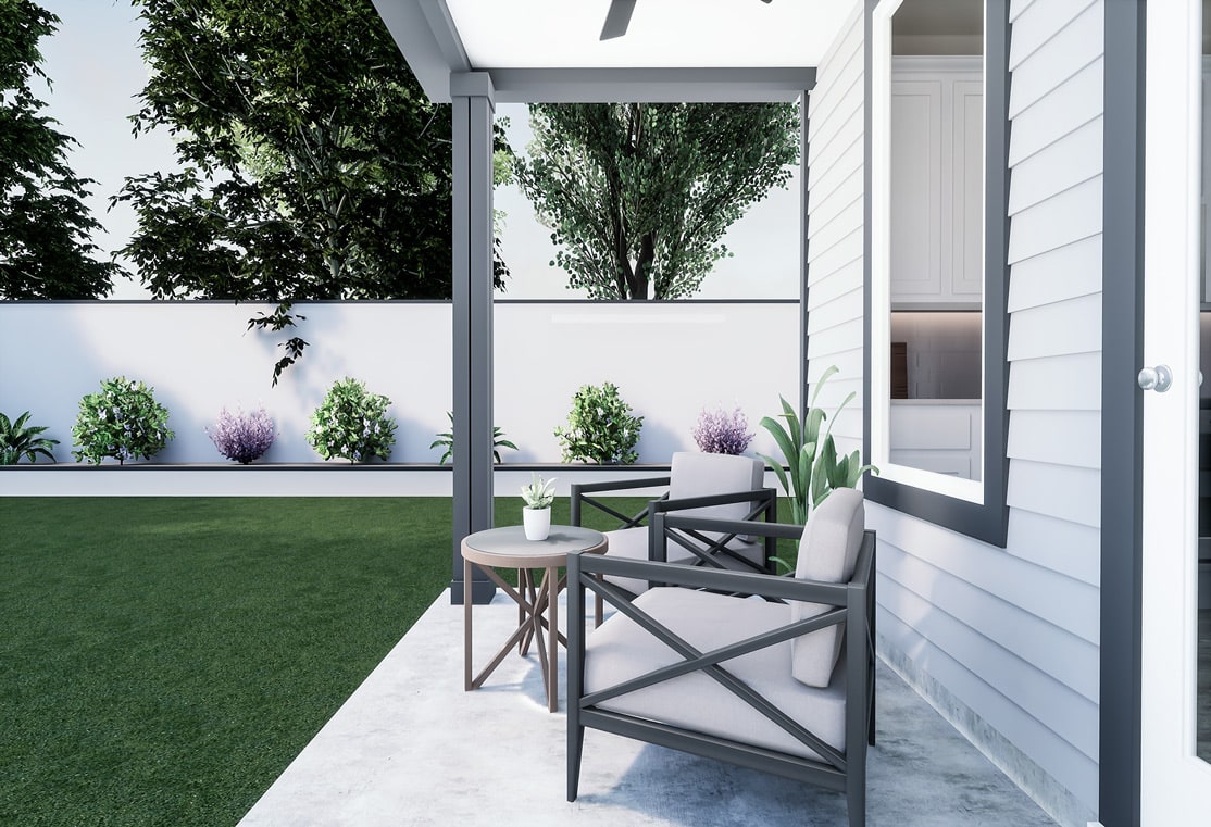 A modern outdoor patio with a lush green artificial lawn, surrounded by potted plants and a white wooden structure with large windows overlooking the trees in the background.