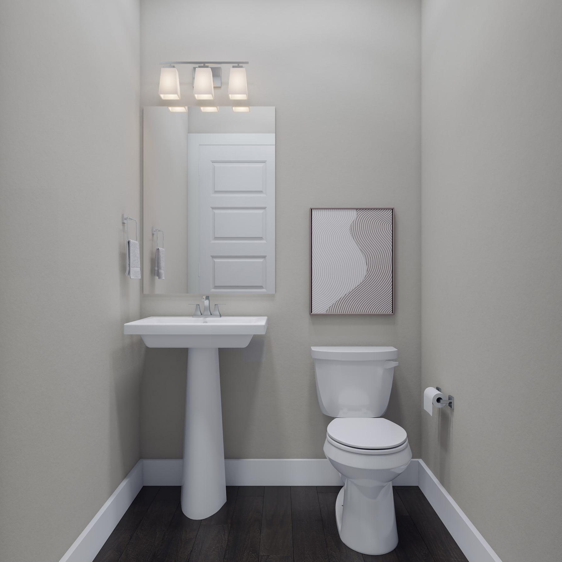 A modern, minimalist bathroom with a white pedestal sink, toilet, and three-light fixture above a framed artwork on the wall.
