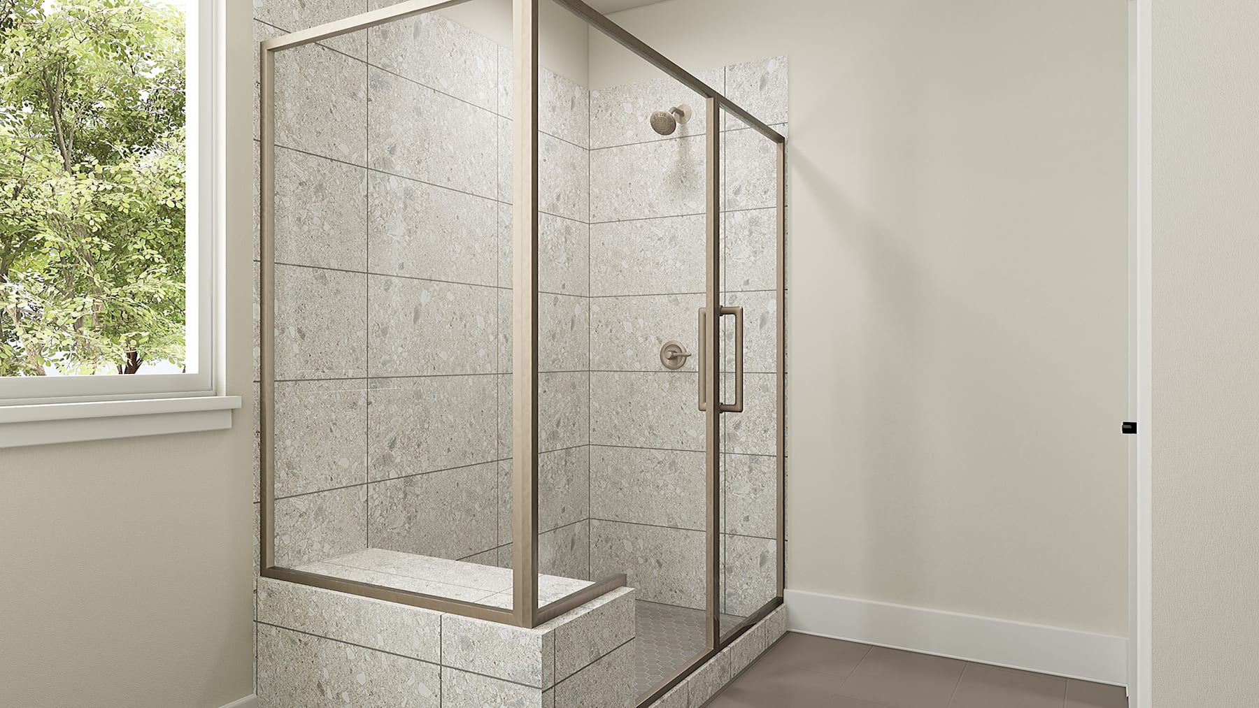 A modern, tiled shower enclosure with a glass door and frame, set against a plain white wall and surrounded by a lush, green outdoor view through a window.