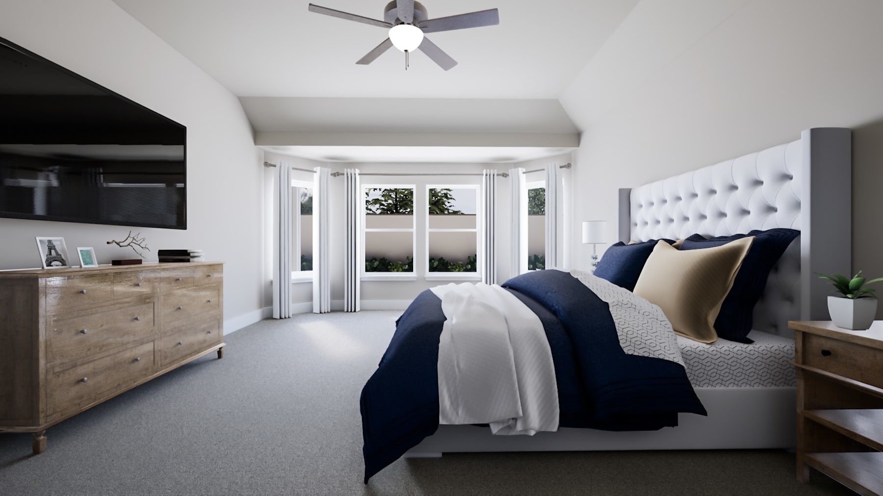 A cozy and modern bedroom with a large bed, wooden furniture, and a ceiling fan, overlooking a scenic outdoor view through the large windows.