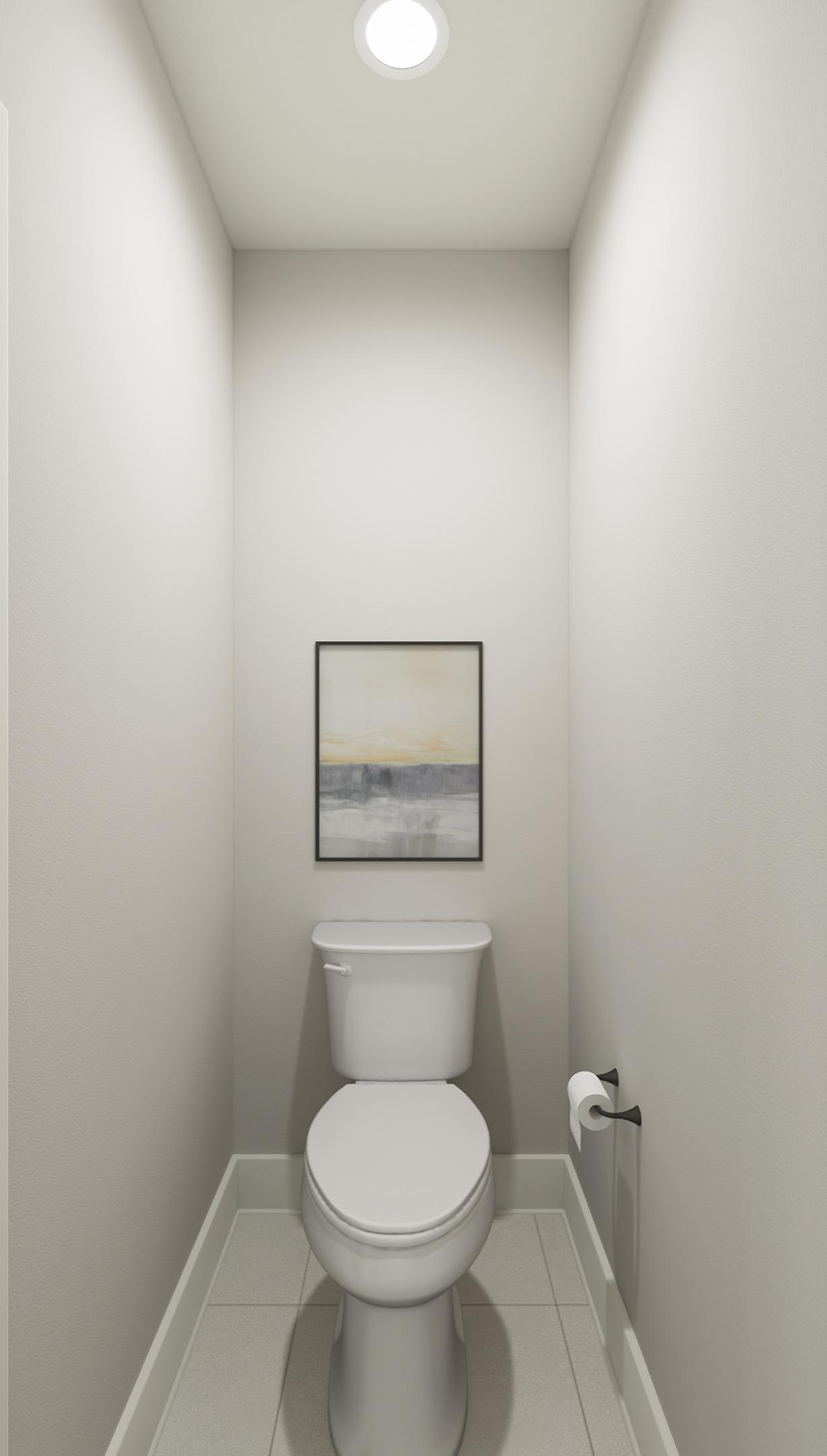 A simple and minimalist bathroom with a white toilet, a framed artwork on the wall, and a clean, neutral-toned interior.