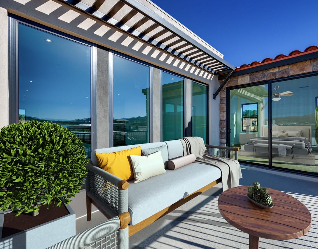 A modern outdoor patio with a cozy seating area, surrounded by lush greenery and overlooking a scenic landscape.