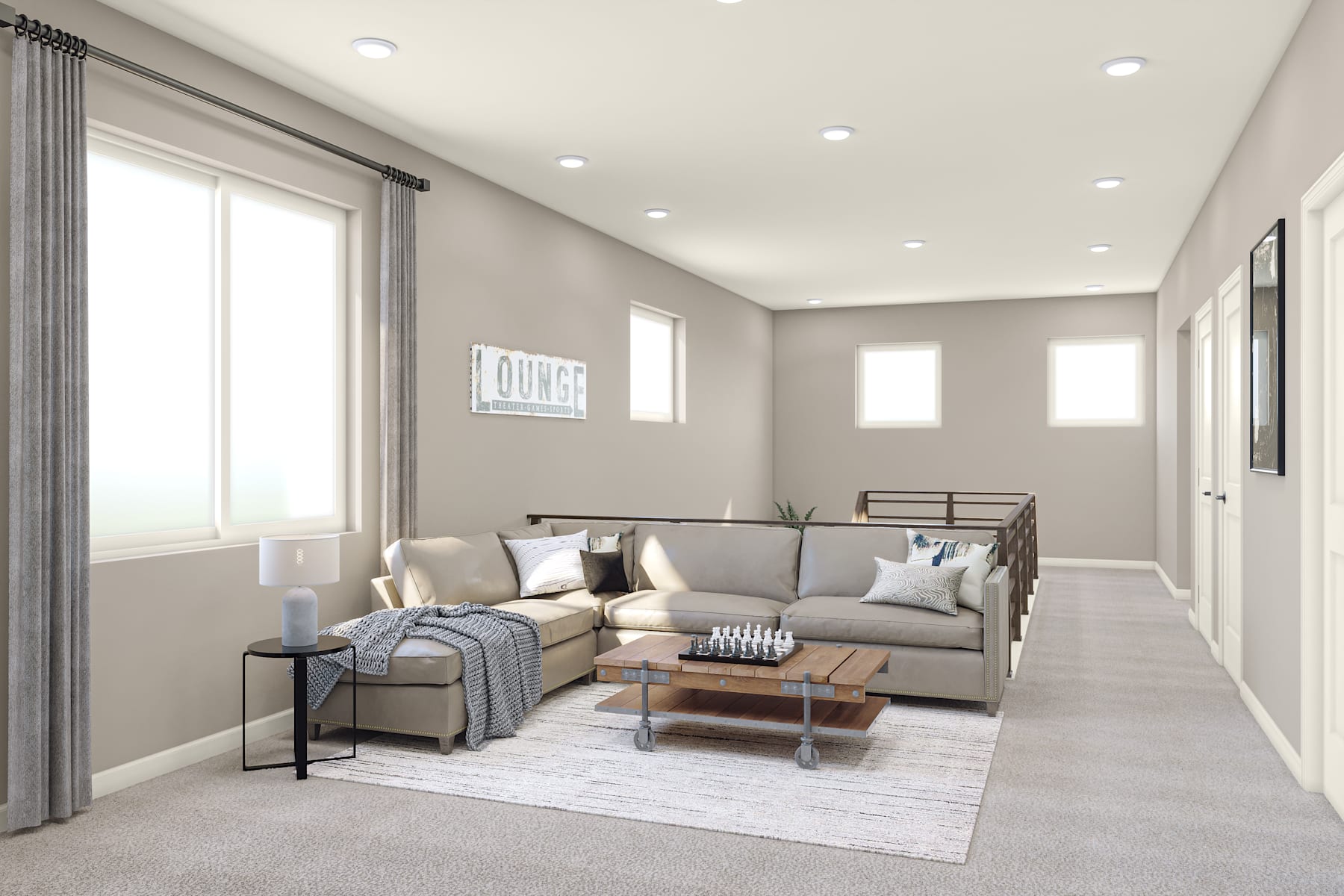 A cozy and modern living room with a gray sectional sofa, a wooden coffee table, and a rug on the light-colored hardwood floor, surrounded by neutral-toned walls and recessed lighting.