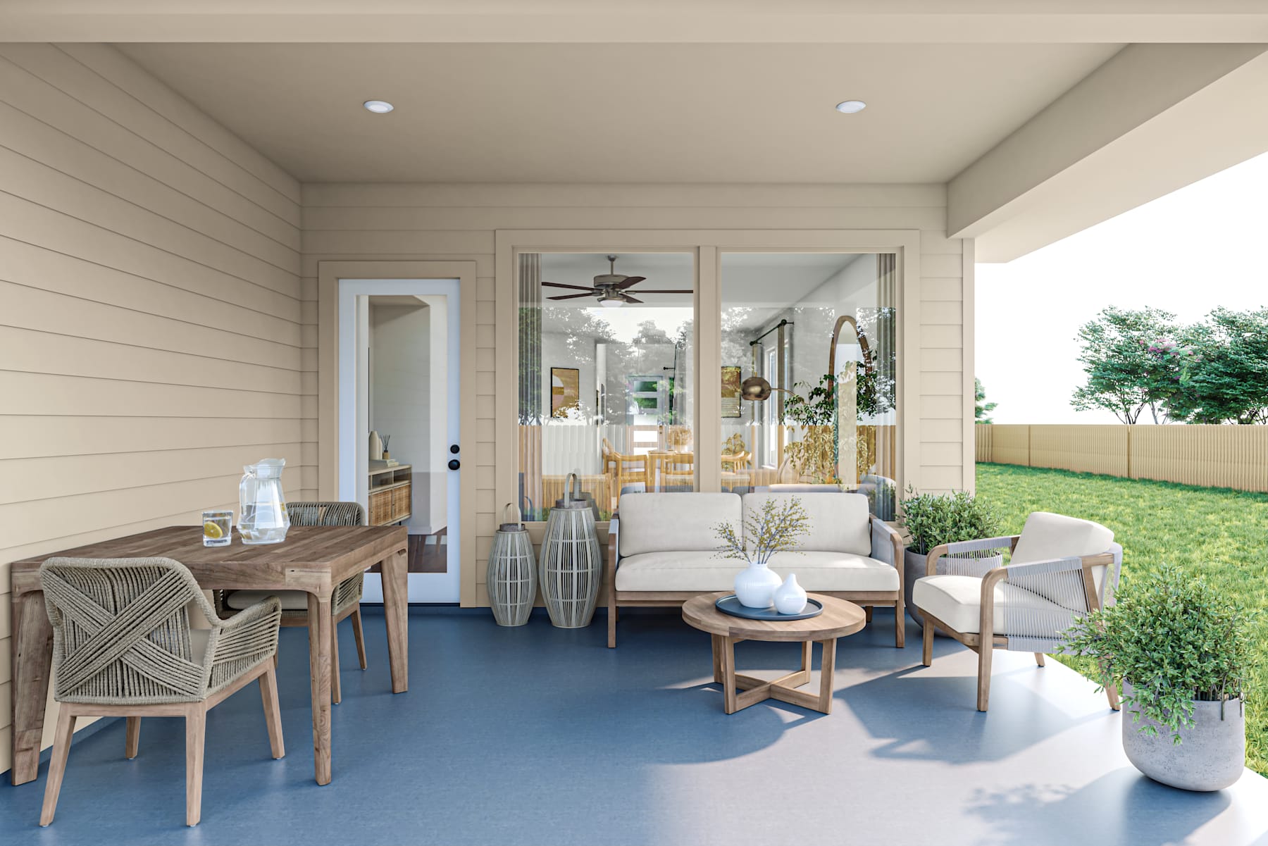 A cozy and inviting outdoor living space with a wooden dining table, comfortable seating, and decorative accents, surrounded by a lush green yard.