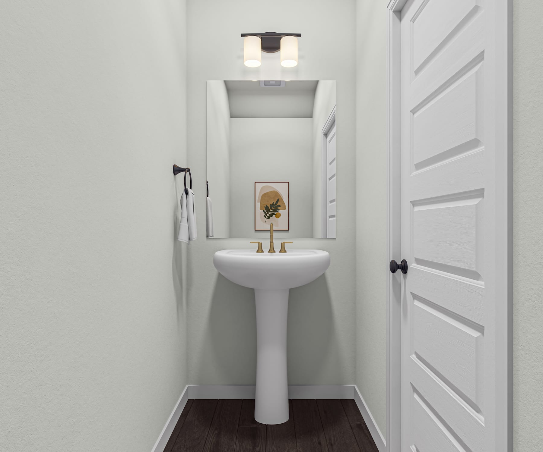 A clean, minimalist bathroom with a white pedestal sink, a framed artwork on the wall, and a recessed lighting fixture above.