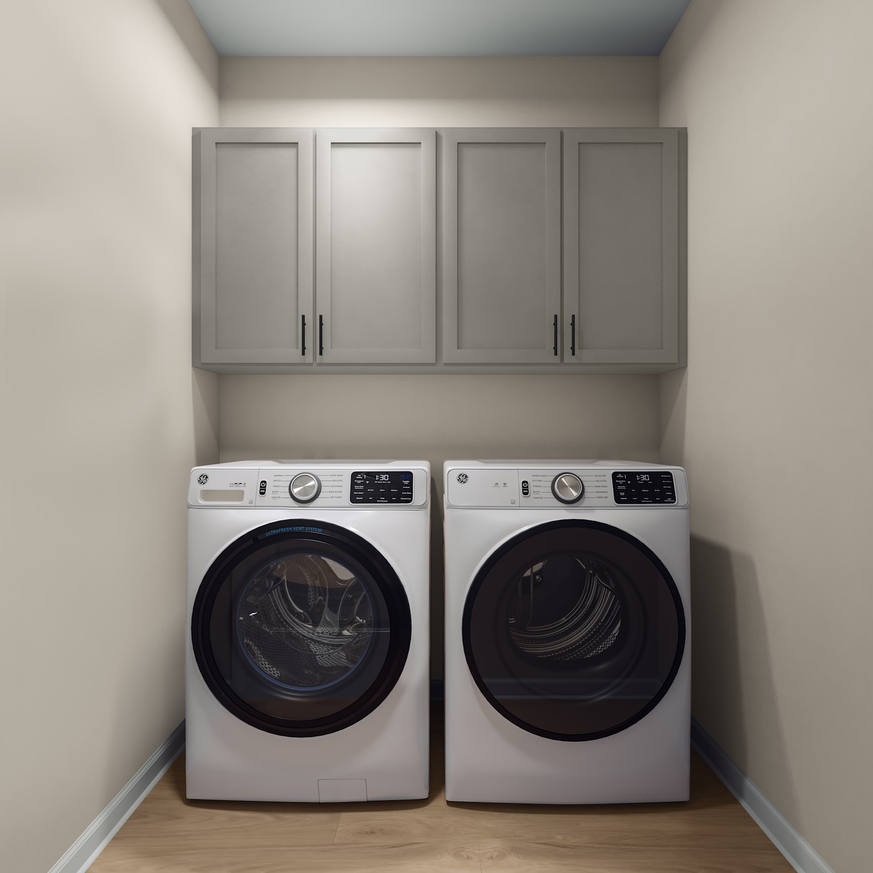 A modern laundry room with white appliances, gray cabinets, and a tiled floor.