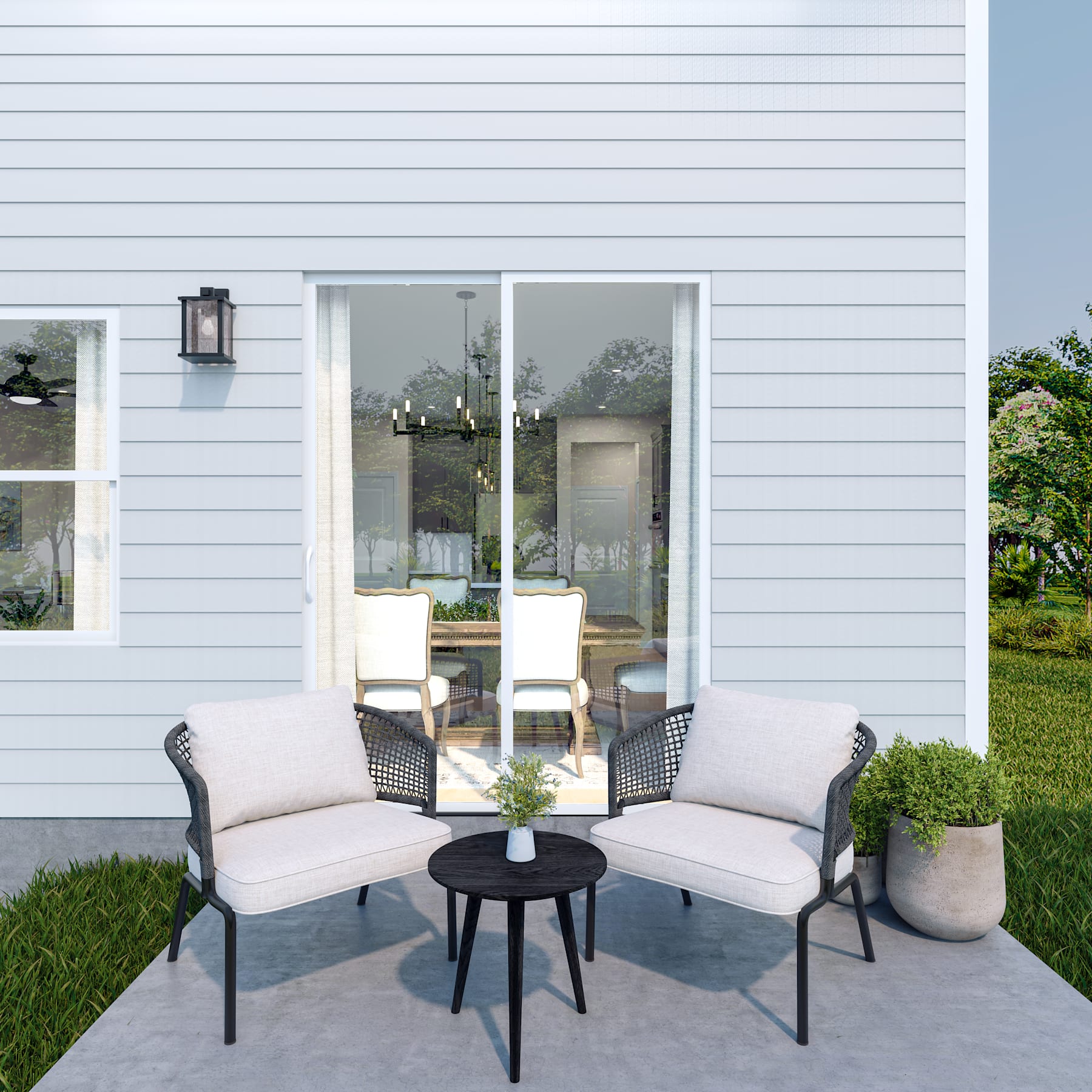 A cozy outdoor seating area with comfortable chairs and a small table, set against the backdrop of a modern, white-paneled building with large windows.