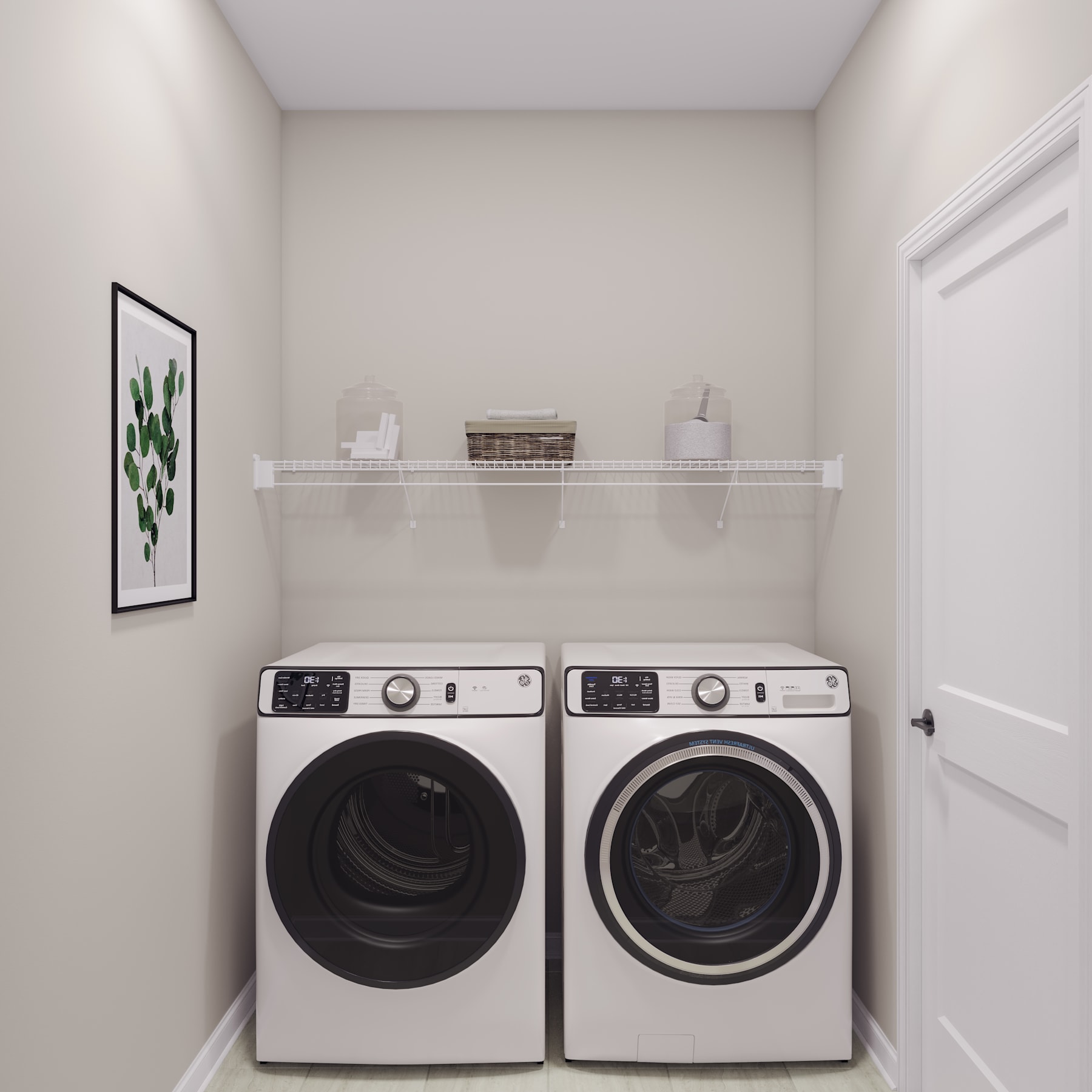 A modern and minimalist laundry room with a white washer and dryer set against a plain white wall, with a small framed artwork and a decorative shelf above the appliances.