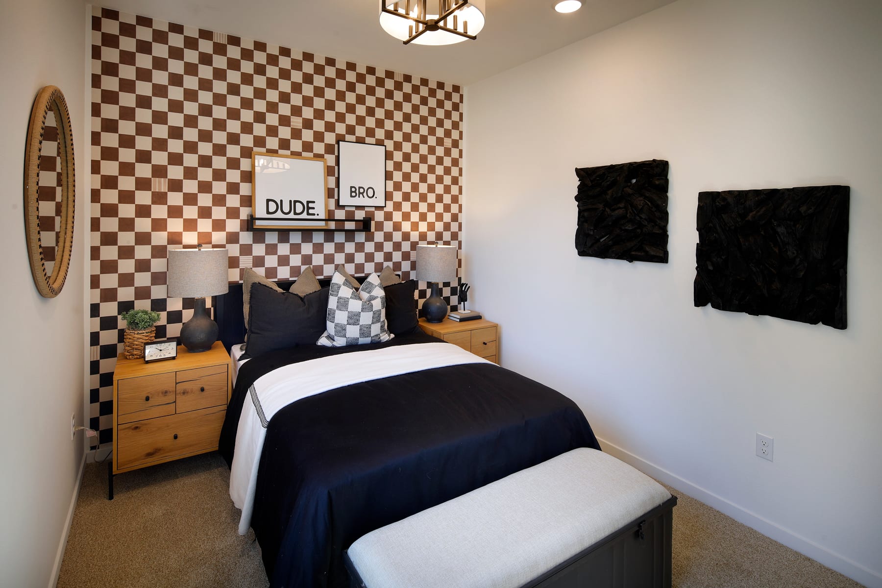 A cozy and stylish bedroom with a checkered accent wall, a wooden dresser, and various decorative elements, creating a modern and inviting atmosphere.