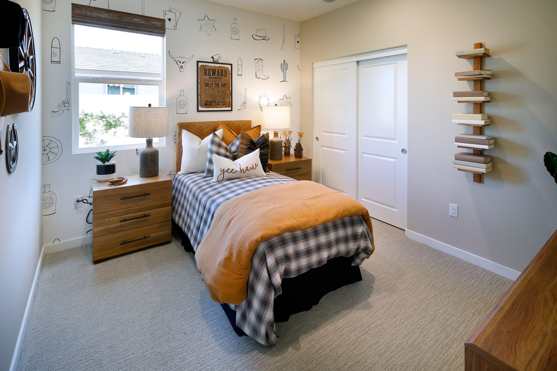 A cozy and well-furnished bedroom with a bed, nightstand, and shelving unit, set against a bright and airy background.