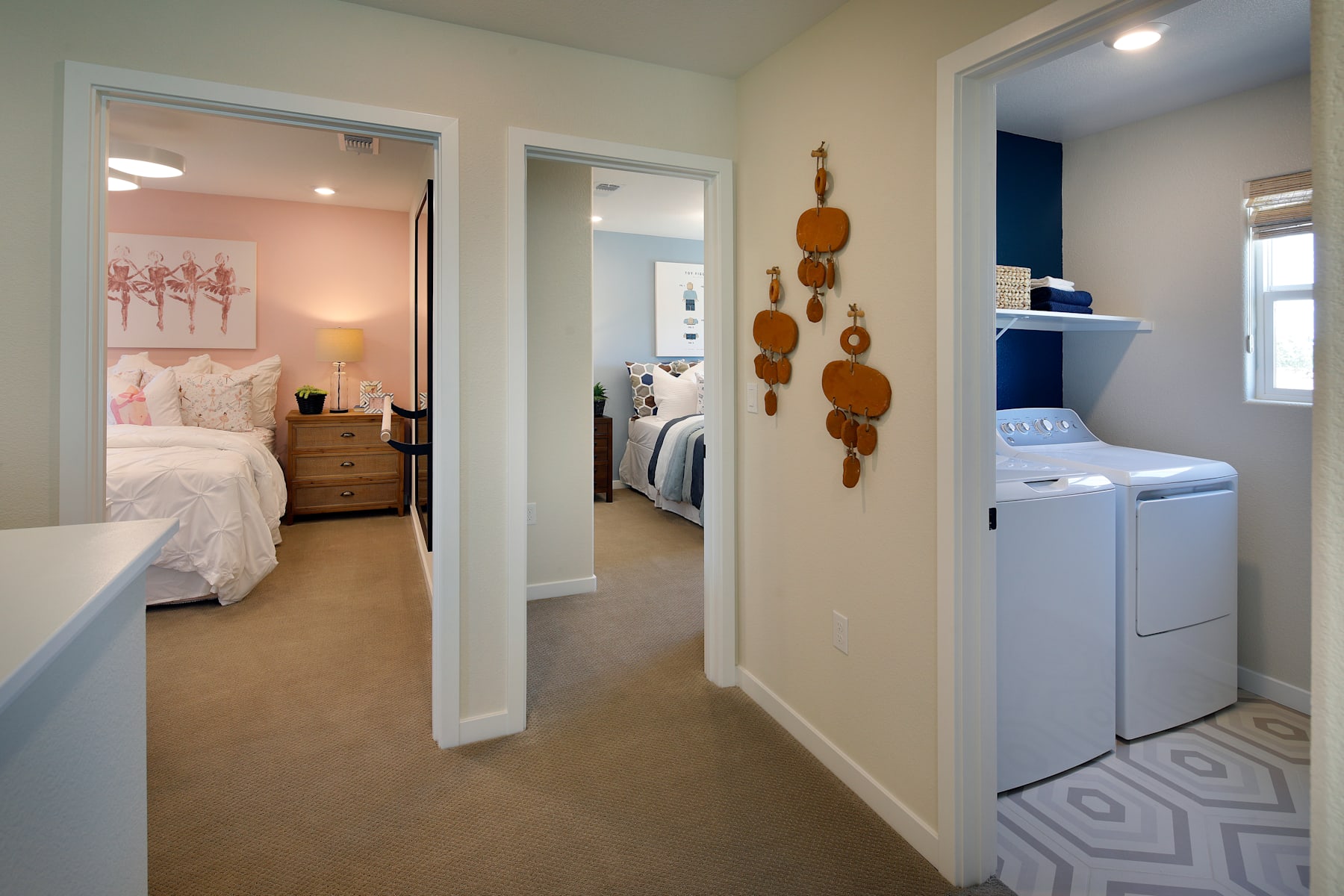 A cozy and well-designed bedroom and laundry room, with a warm color palette, wooden accents, and modern appliances.