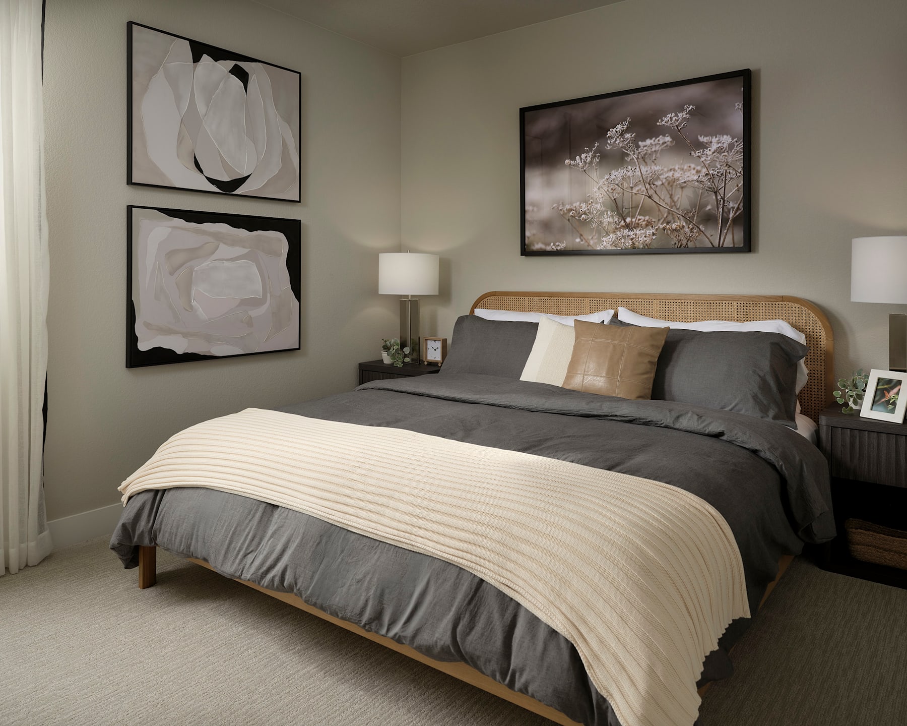 A cozy and inviting bedroom with a large bed, neutral-toned bedding, and framed artwork on the walls, creating a serene and calming atmosphere.
