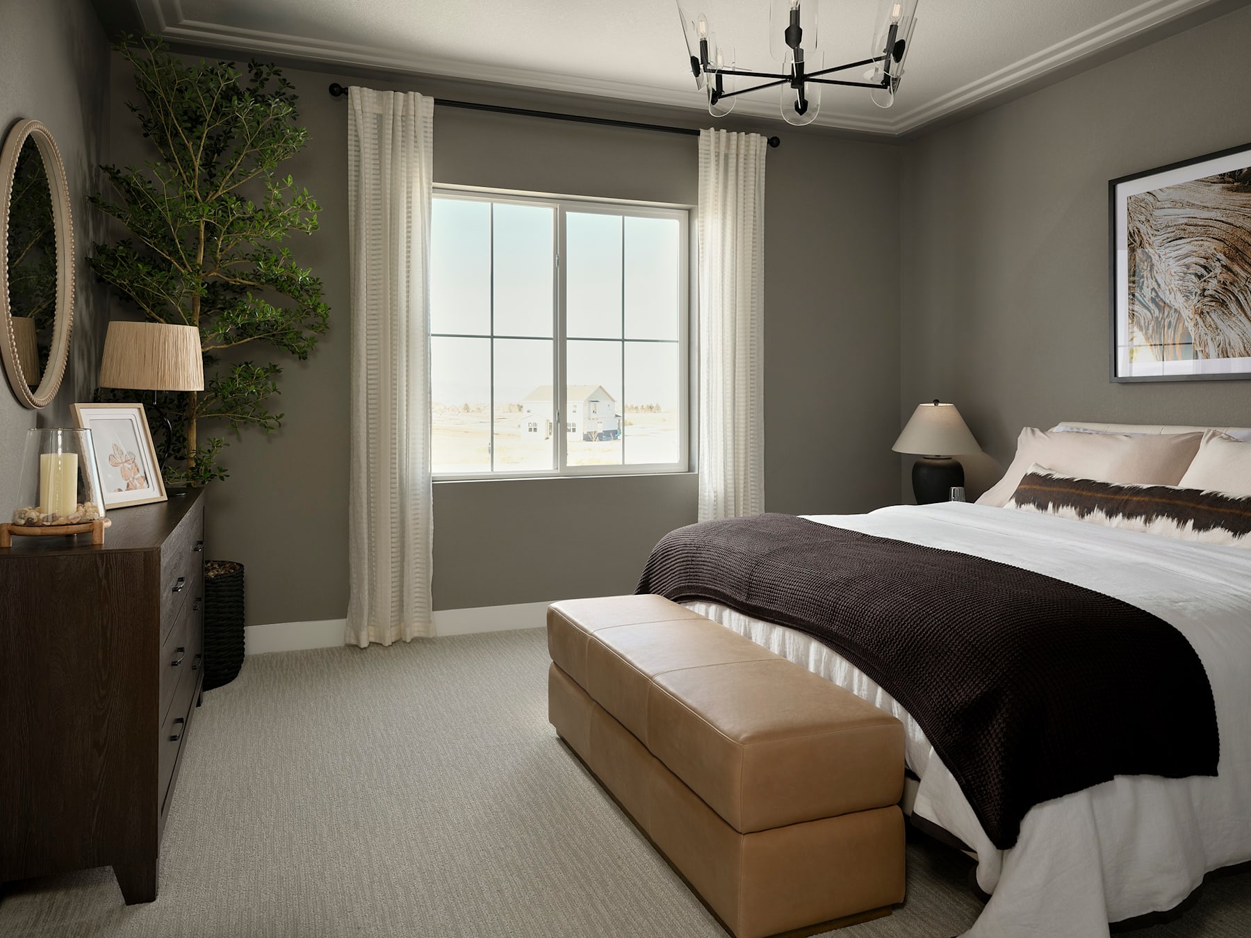 A cozy and inviting bedroom with a large window, a plush bed with a dark comforter, and a potted plant adding a touch of greenery to the neutral-toned space.