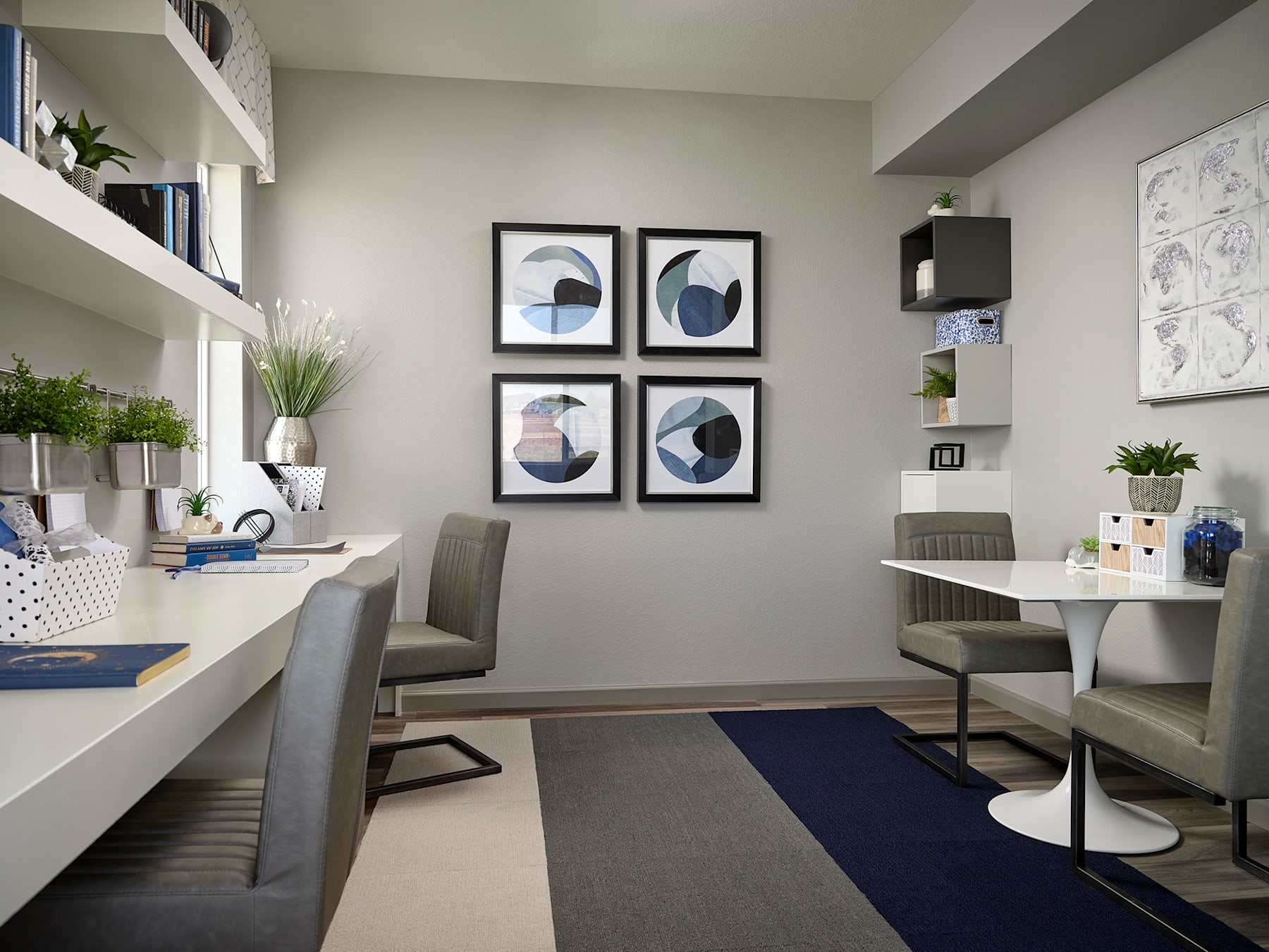 A modern and minimalist home office space with white walls, gray furniture, and abstract artwork displayed on the wall.